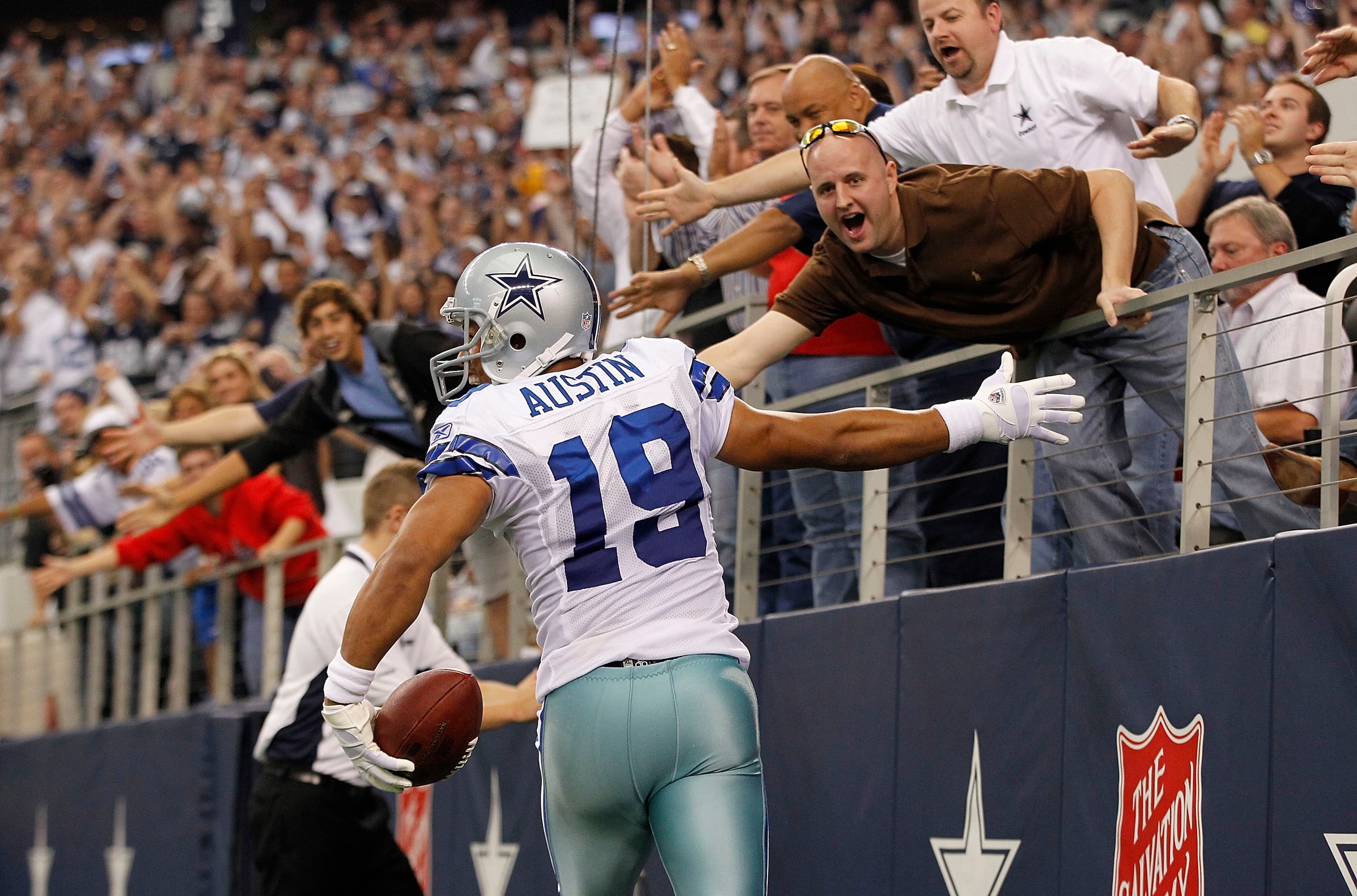 ARLINGTON, TX - NOVEMBER 21: Miles Austin #19 of the Dallas Cowboys scores a third quarter touchdown on a 3 yard pass from Jon Kitna #3 and celebrates with the fans during the game at Dallas Stadium on November 21, 2010 in Arlington, Texas. The Cowboys d ARLINGTON, TX - NOVEMBER 21: Miles Austin #19 of the Dallas Cowboys scores a third quarter touchdown on a 3 yard pass from Jon Kitna #3 and celebrates with the fans during the game at Dallas Stadium on November 21, 2010 in Arlington, Texas. The Cowboys d