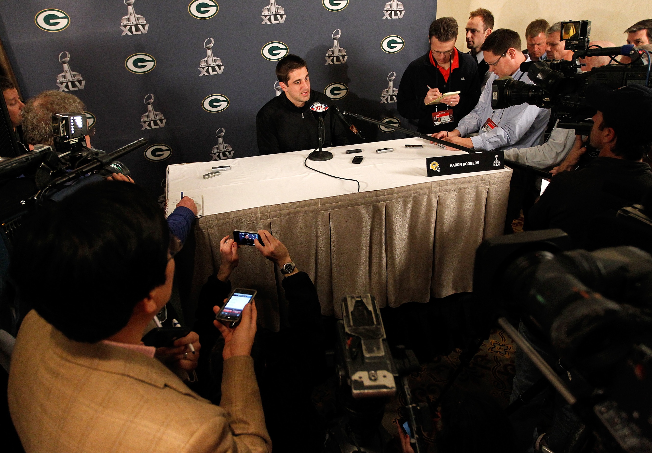 IRVING, TX - JANUARY 31: Quarterback Aaron Rodgers #12 of the Green Bay Packers talks to the media on January 31, 2011 in Irving, Texas. The Green Bay Packers will play the Pittsburgh Steelers in Super Bowl XLV on February 6, 2011 at Cowboys Stadium in A IRVING, TX - JANUARY 31: Quarterback Aaron Rodgers #12 of the Green Bay Packers talks to the media on January 31, 2011 in Irving, Texas. The Green Bay Packers will play the Pittsburgh Steelers in Super Bowl XLV on February 6, 2011 at Cowboys Stadium in A