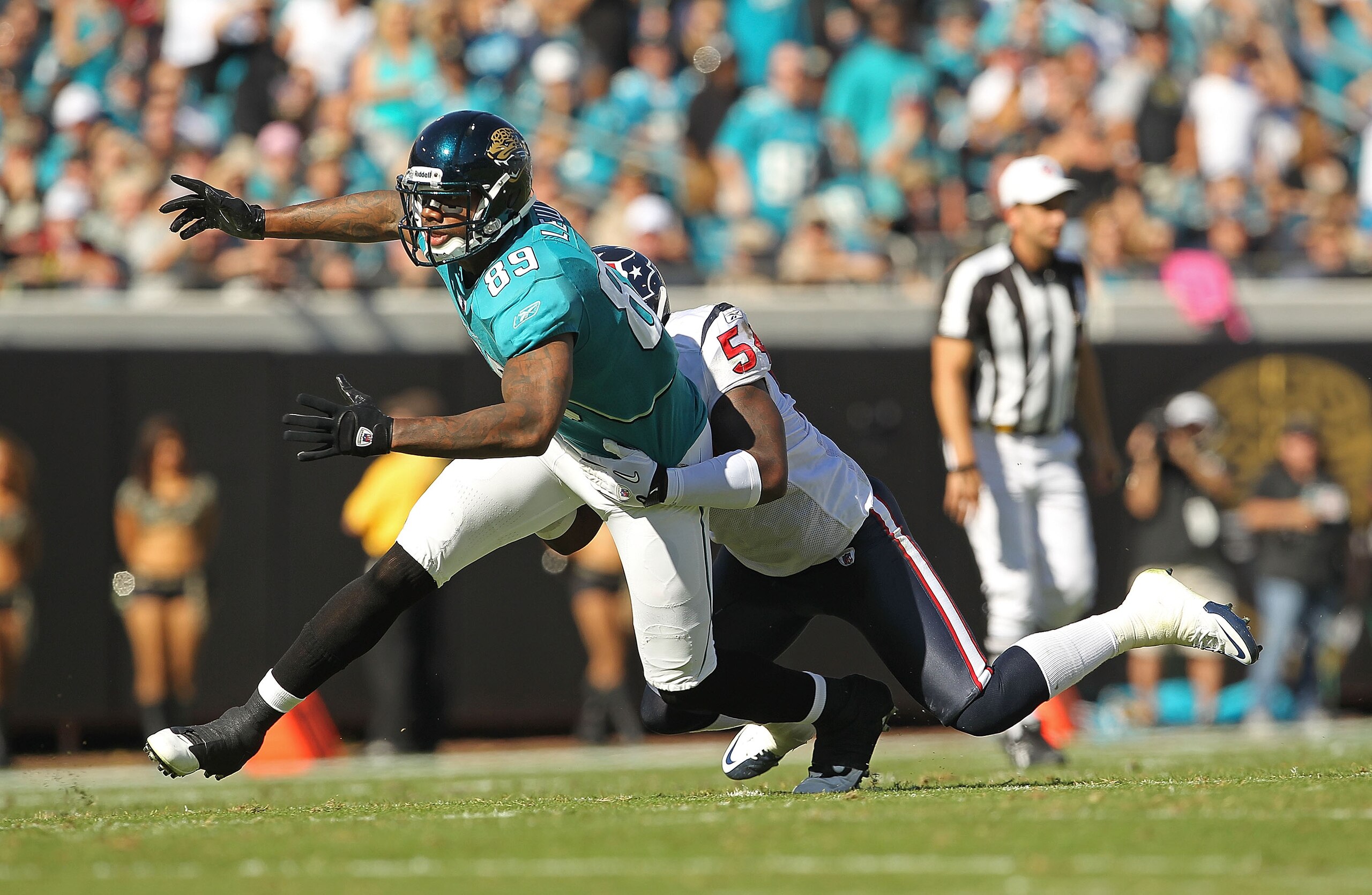 JACKSONVILLE, FL - NOVEMBER 14:  Marcedes Lewis #89 of the Jacksonville Jaguars misses a catch before being tackled by Zac Diles #54 during a game against the Houston Texans at EverBank Field on November 14, 2010 in Jacksonville, Florida.  (Photo by Mike