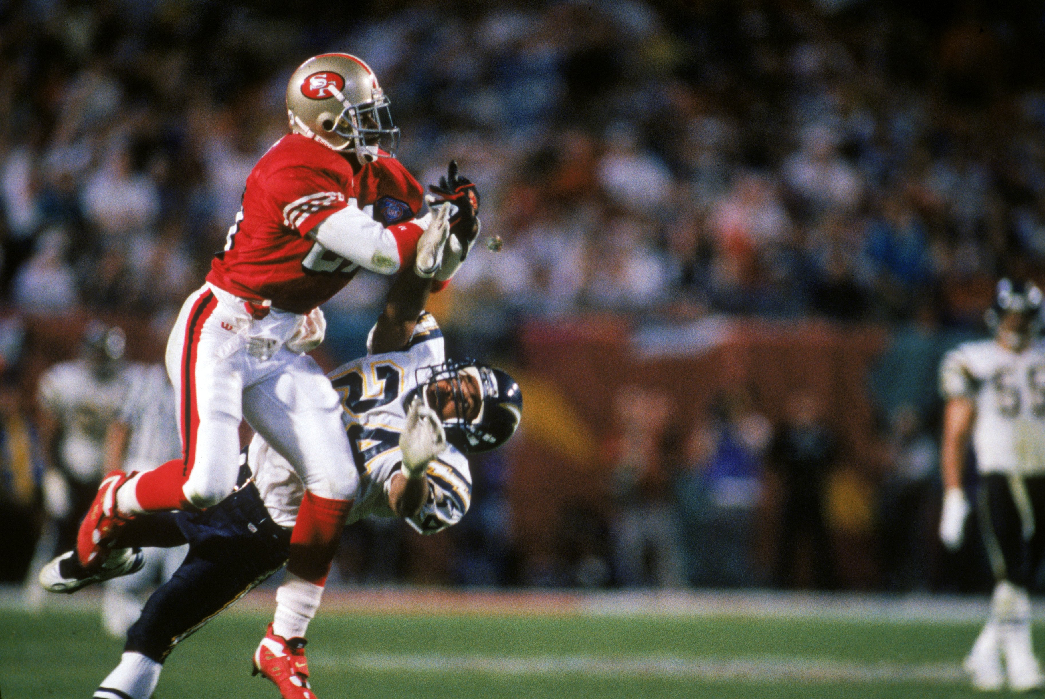 MIAMI - JANUARY 29:  Deion Sanders #21 of the San Francisco 49ers goes up to make a catch against Stanley Richard #24 of the San Diego Chargers during Super Bowl XXIX at Joe Robbie Stadium on January 29, 1995 in Miami, Florida. The 49ers won 49-26. (Photo