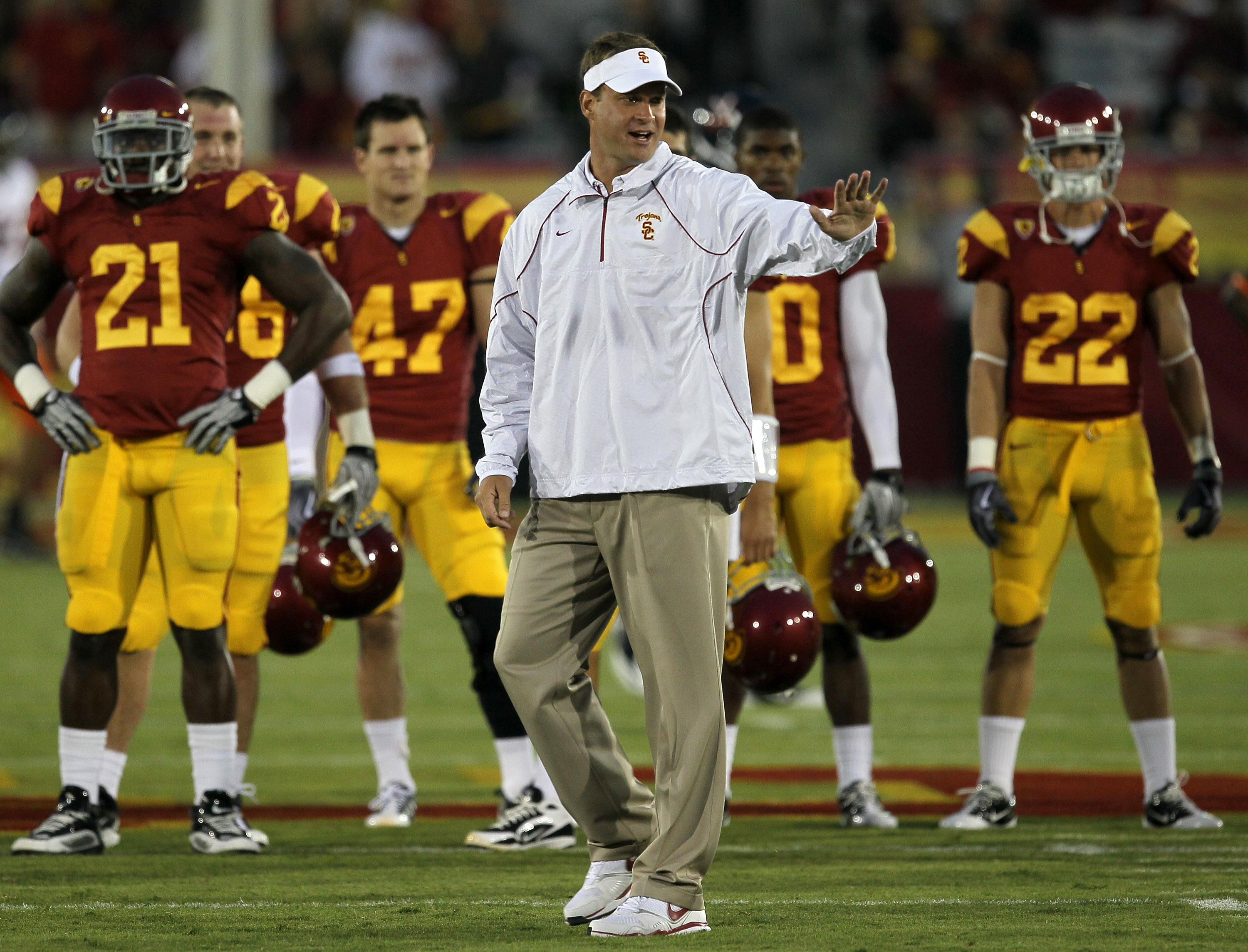 LOS ANGELES, CA - SEPTEMBER 11:  Head coach Lane Kiffin gestures as the USC Trojans warm up for their game with the Virginia Cavaliers at Los Angeles Memorial Coliseum on September 11, 2010 in Los Angeles, California.  (Photo by Stephen Dunn/Getty Images)