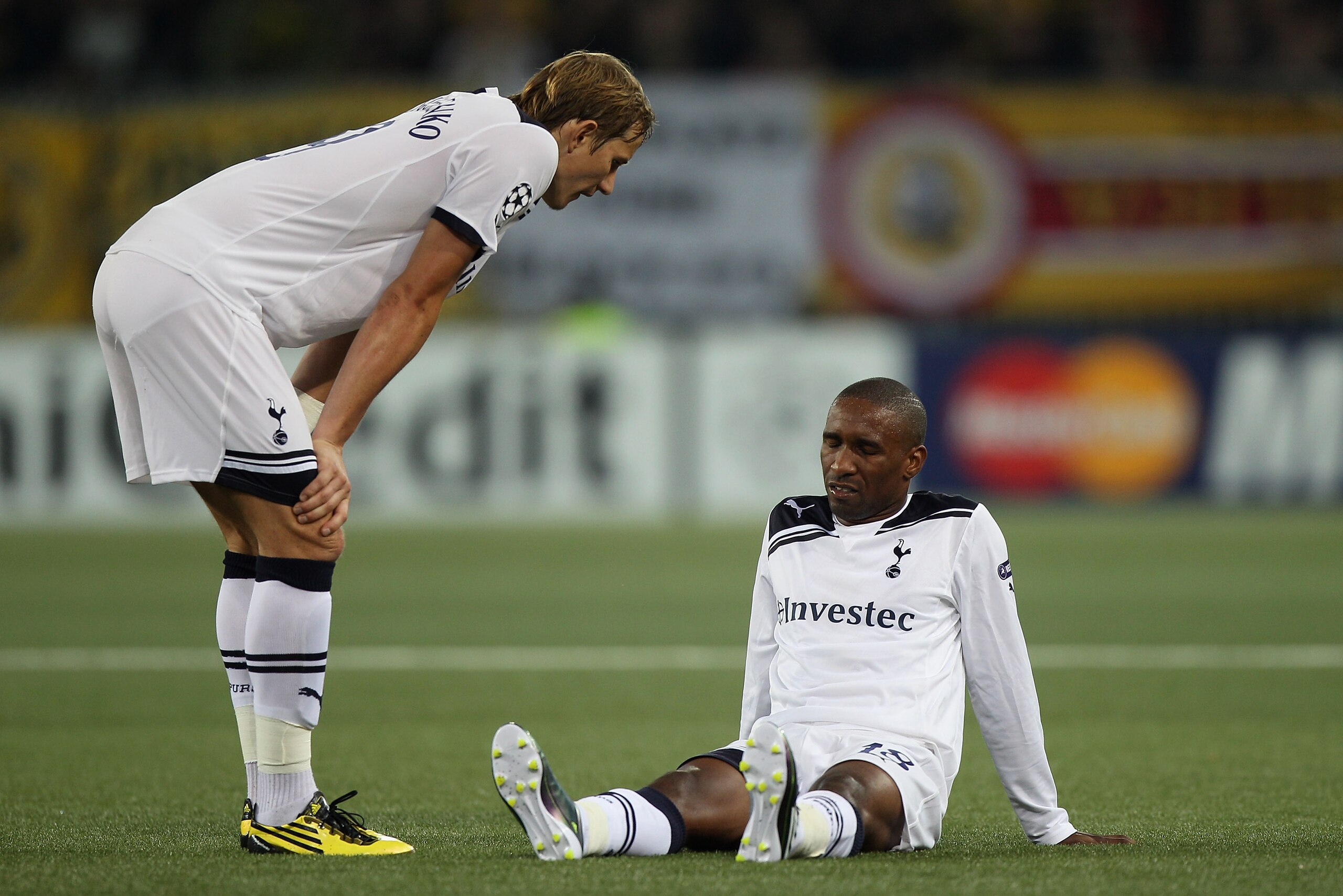 BERNE, SWITZERLAND - AUGUST 17: Jermain Defoe (r) lies injured as Roman Pavlyuchenko (l) looks on during the UEFA Champions League Play-Off first leg match between BSC Young Boys and Tottenham Hotspur at the Stade de Suisse on August 17, 2010 in Berne, Sw