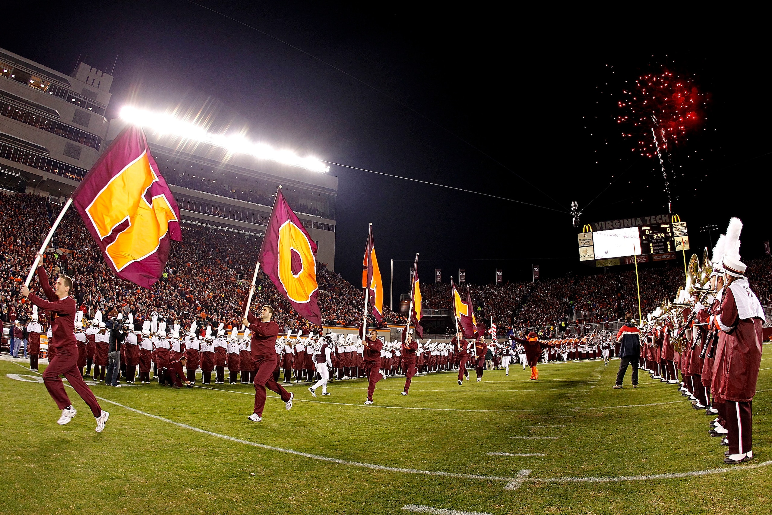 BLACKSBURG, VA - NOVEMBER 04: Cheerleaders from the Virginia Tech Hokies lead the players onto the field prior to the Hokies game against the Georgia Tech Yellow Jackets at Lane Stadium on November 4, 2010 in Blacksburg, Virginia.  (Photo by Geoff Burke/G