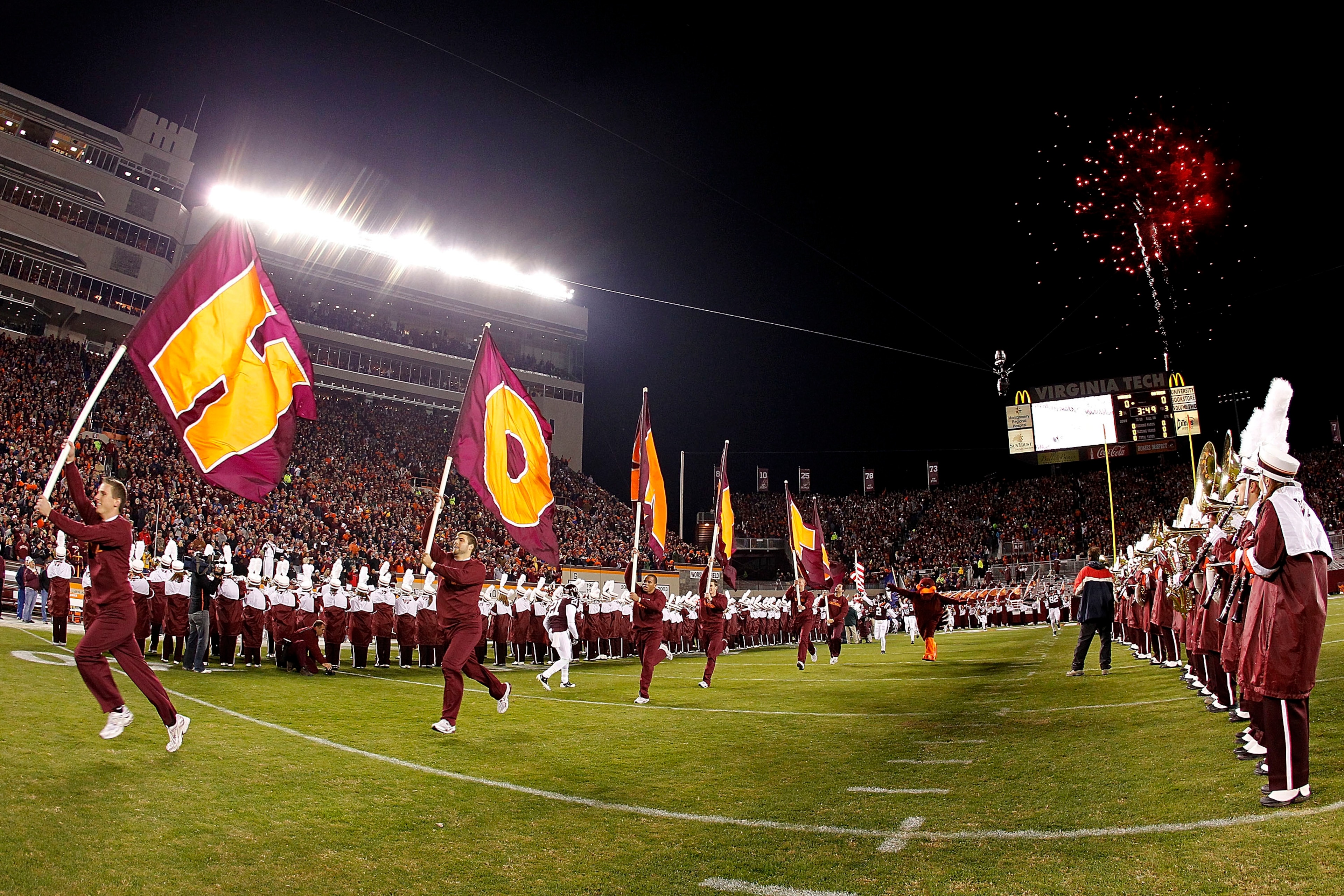 BLACKSBURG, VA - NOVEMBER 04: Cheerleaders from the Virginia Tech Hokies lead the players onto the field prior to the Hokies game against the Georgia Tech Yellow Jackets at Lane Stadium on November 4, 2010 in Blacksburg, Virginia. (Photo by Geoff Burke/G BLACKSBURG, VA - NOVEMBER 04: Cheerleaders from the Virginia Tech Hokies lead the players onto the field prior to the Hokies game against the Georgia Tech Yellow Jackets at Lane Stadium on November 4, 2010 in Blacksburg, Virginia. (Photo by Geoff Burke/G