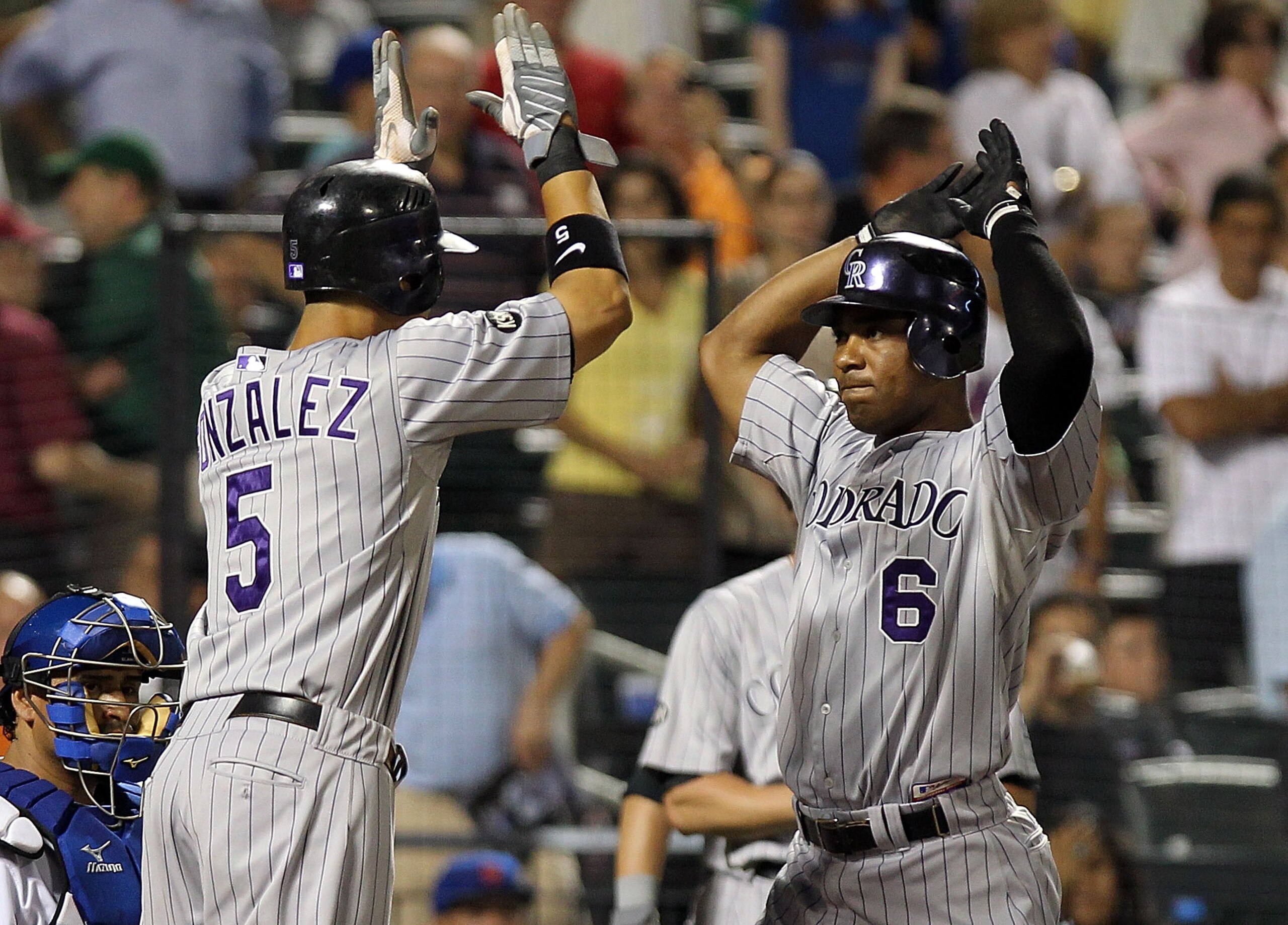 NEW YORK - AUGUST 11: Melvin Mora #6 of the Colorado Rockies celebrates with teammate Carlos Gonzalez #5 after he hit a grand slam home run in the 8th inning against the New York Mets at Citi Field on August 11, 2010 in the Flushing neighborhood of the Q NEW YORK - AUGUST 11: Melvin Mora #6 of the Colorado Rockies celebrates with teammate Carlos Gonzalez #5 after he hit a grand slam home run in the 8th inning against the New York Mets at Citi Field on August 11, 2010 in the Flushing neighborhood of the Q