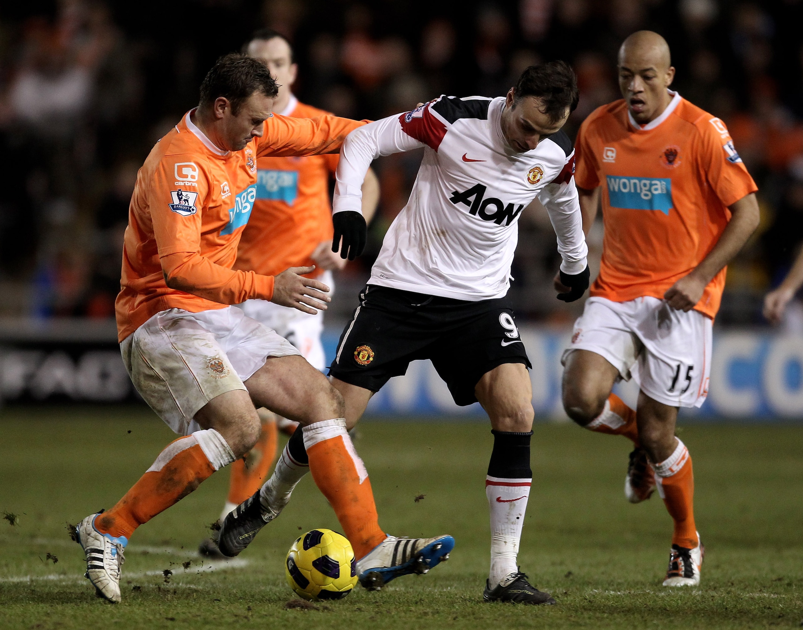 BLACKPOOL, ENGLAND - JANUARY 25:  Craig Cathcart of Blackpool challenges Dimitar Berbatov of Manchester United during the Barclays Premier League match between Blackpool and Manchester United at Bloomfield Road on January 25, 2011 in Blackpool, England. (