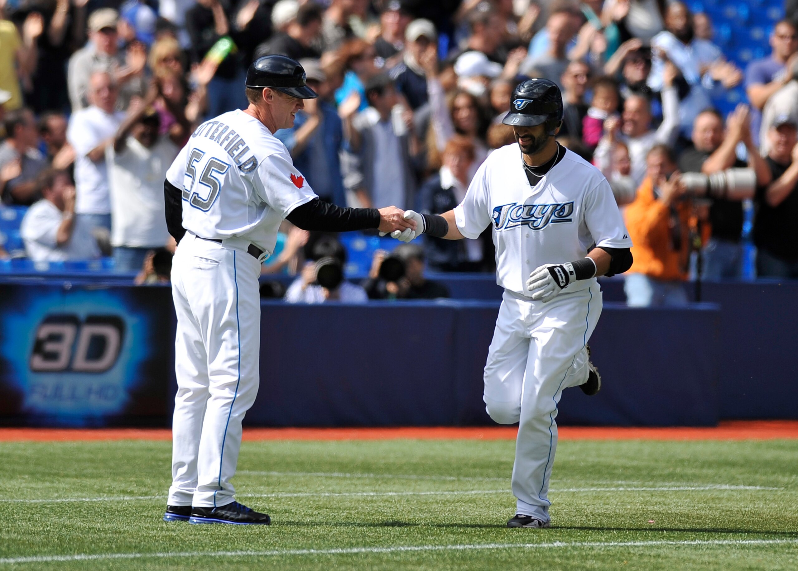 TORONTO - SEPTEMBER 23:  Jose Bautista #19 of the Toronto Blue Jays shakes hands with third base coach Ron Butterfield #55 after hitting his 50th home run of the season against the Seattle Mariners on September 23, 2010 at Rogers Centre in Toronto, Ontari
