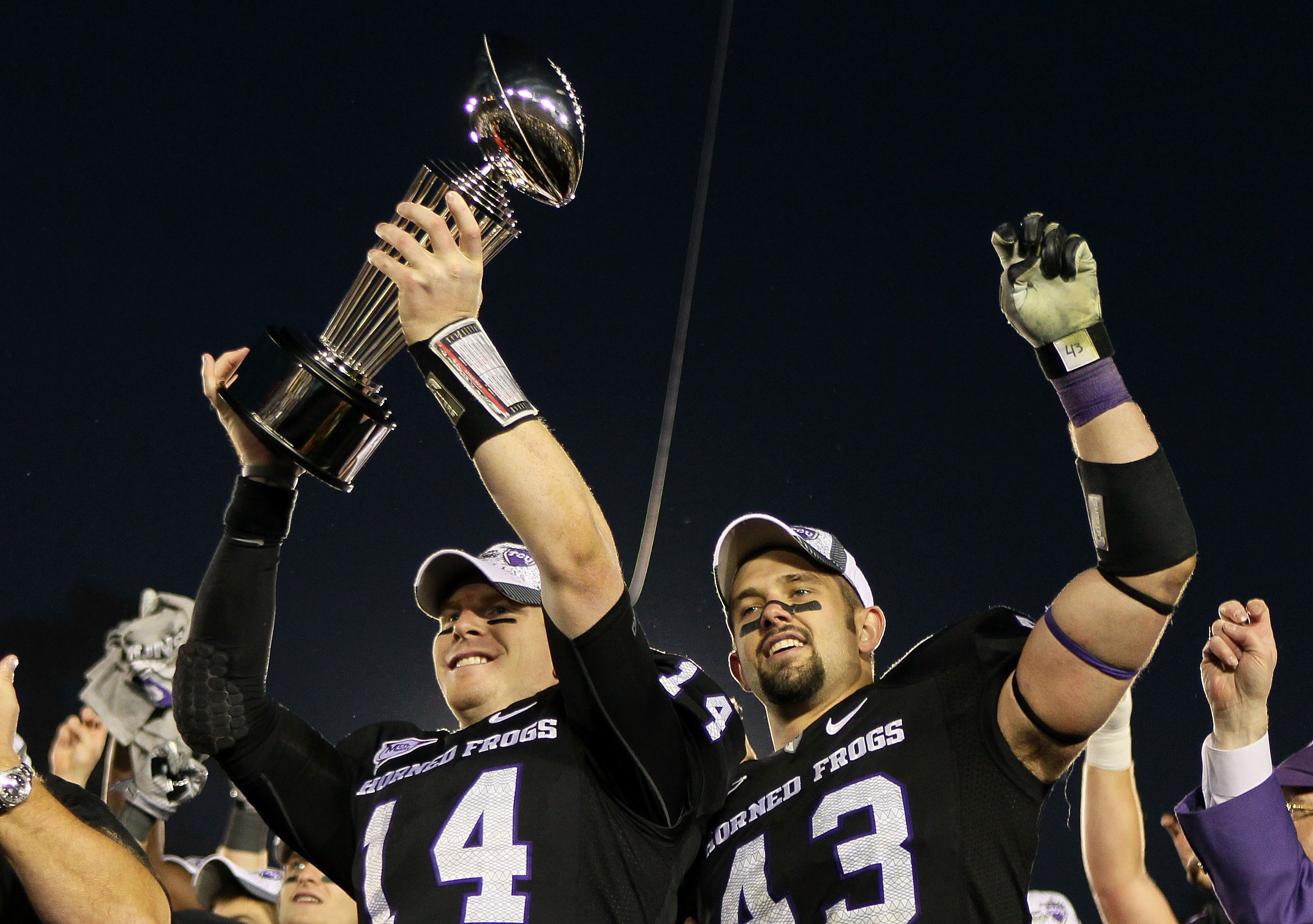 PASADENA, CA - JANUARY 01: Quarterback Andy Dalton #14 and linebacker Tank Carder #43 of the TCU Horned Frogs celebrate with the Rose Bowl Championship Trophy after defeating the Wisconsin Badgers 21-19 in the 97th Rose Bowl game on January 1, 2011 in Pa