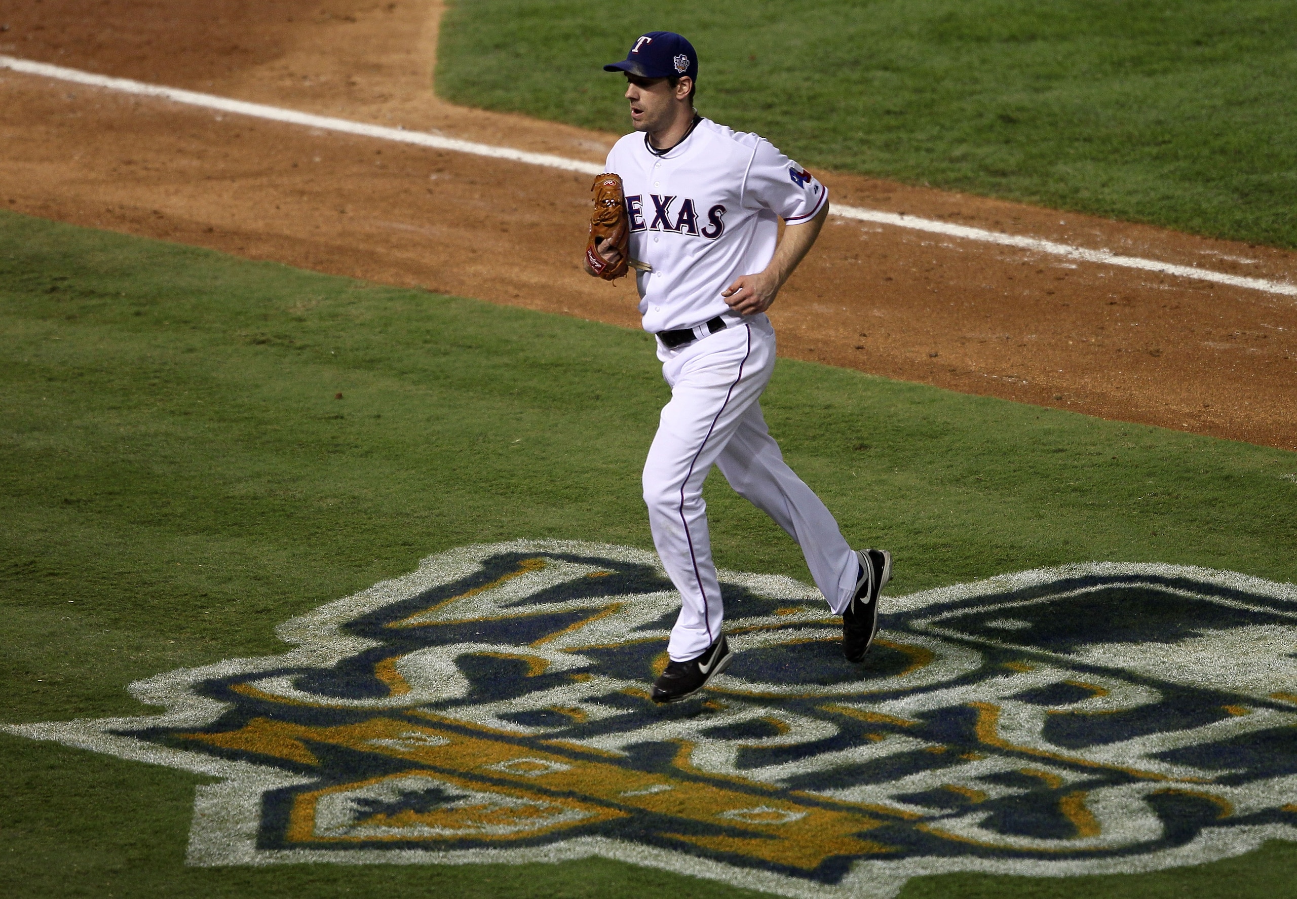 ARLINGTON, TX - NOVEMBER 01:  Cliff Lee #33 of the Texas Rangers runs across the World Series logo on his way to the dugout at the end of an inning against the San Francisco Giants in Game Five of the 2010 MLB World Series at Rangers Ballpark in Arlington