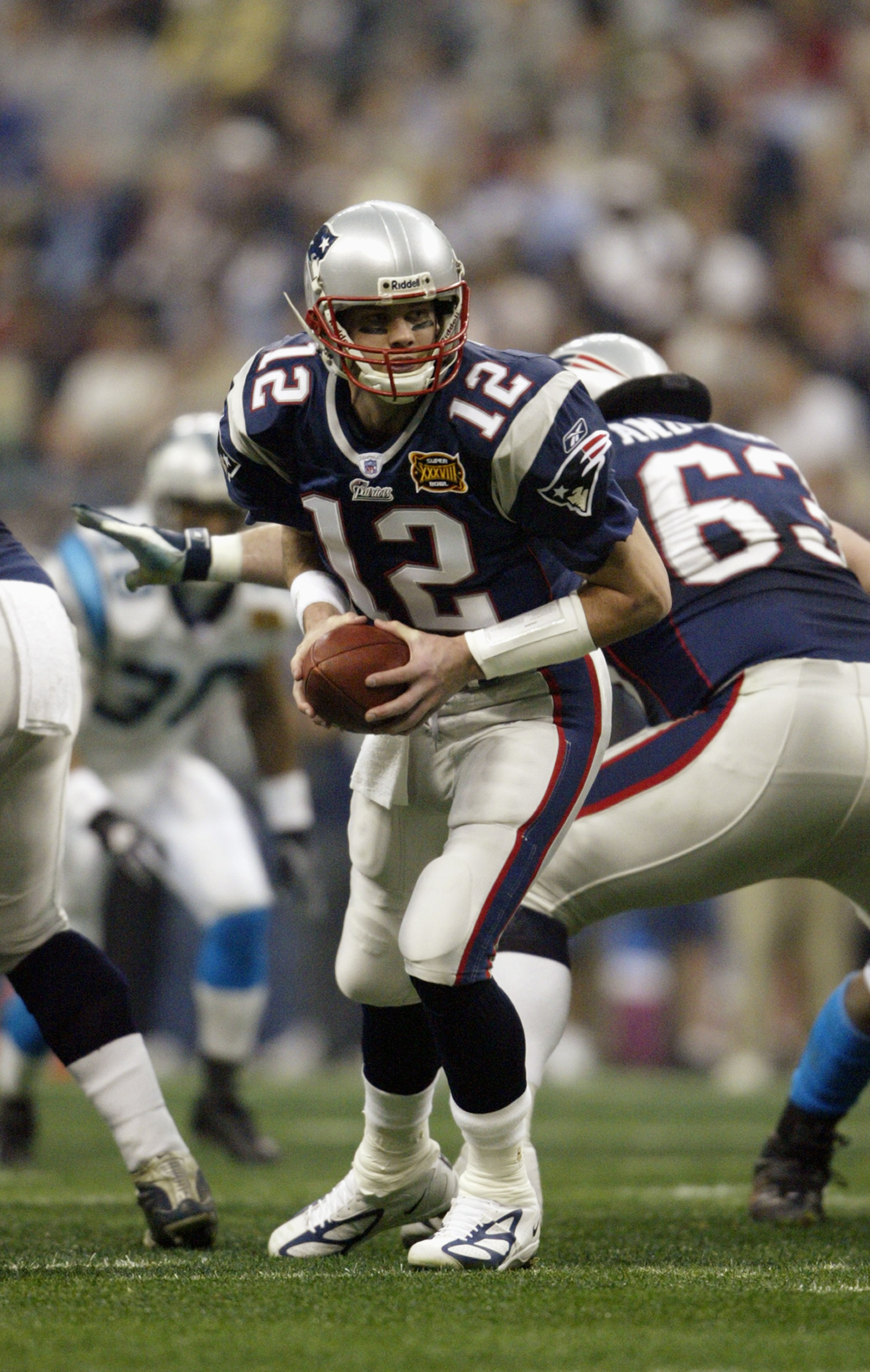HOUSTON - FEBRUARY 1: Qaurterback Tom Brady #12 of the New England Patriots attempts a hand off against the Carolina Panthers during Super Bowl XXXVIII at Reliant Stadium on February 1, 2004 in Houston, Texas. The Patriots defeated the Panthers 32-29. HOUSTON - FEBRUARY 1: Qaurterback Tom Brady #12 of the New England Patriots attempts a hand off against the Carolina Panthers during Super Bowl XXXVIII at Reliant Stadium on February 1, 2004 in Houston, Texas. The Patriots defeated the Panthers 32-29.