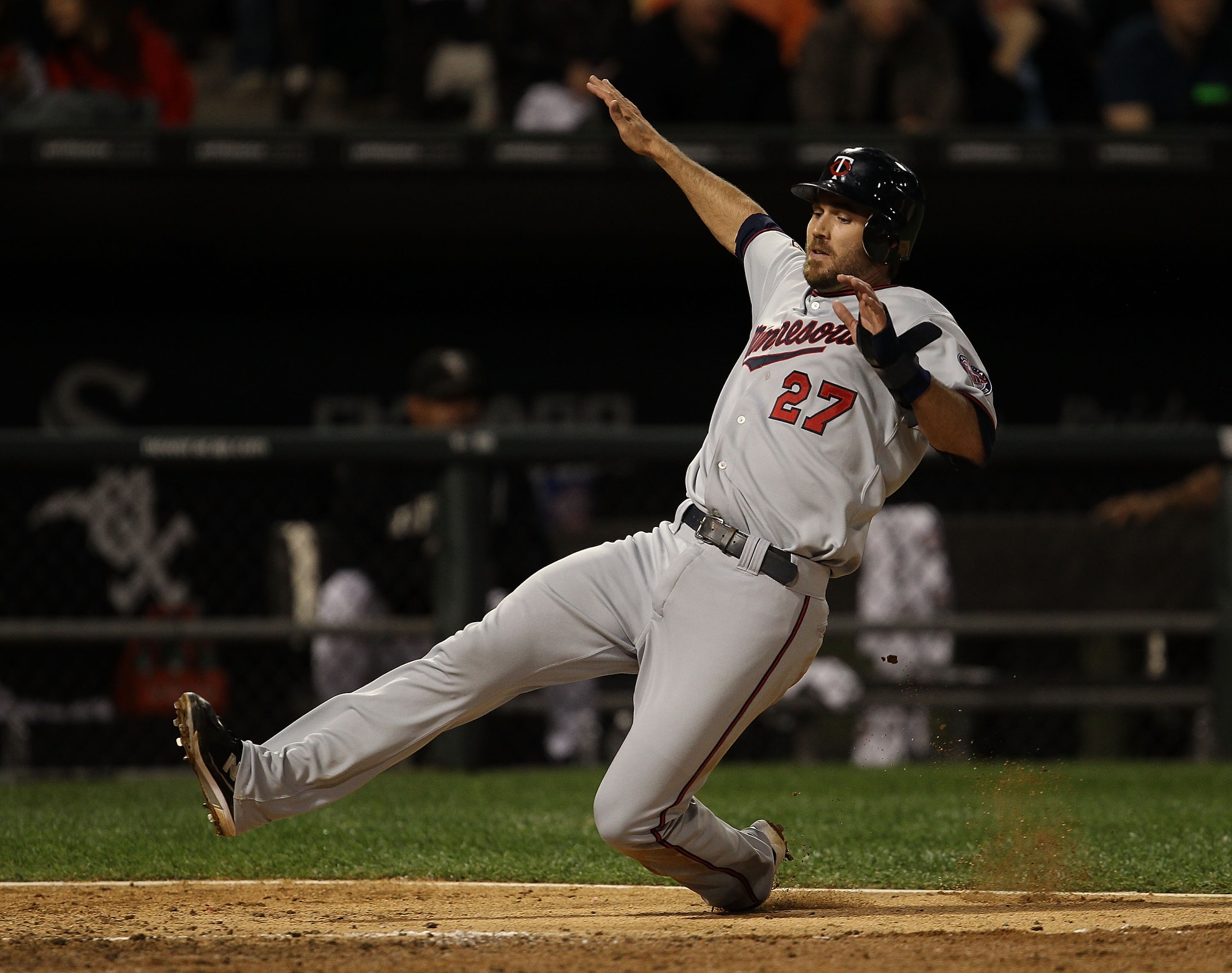CHICAGO - SEPTEMBER 14: J.J. Hardy #27 of the Minnesota Twins slides into the plate to score a run against the Chicago White Sox at U.S. Cellular Field on September 14, 2010 in Chicago, Illinois. (Photo by Jonathan Daniel/Getty Images)