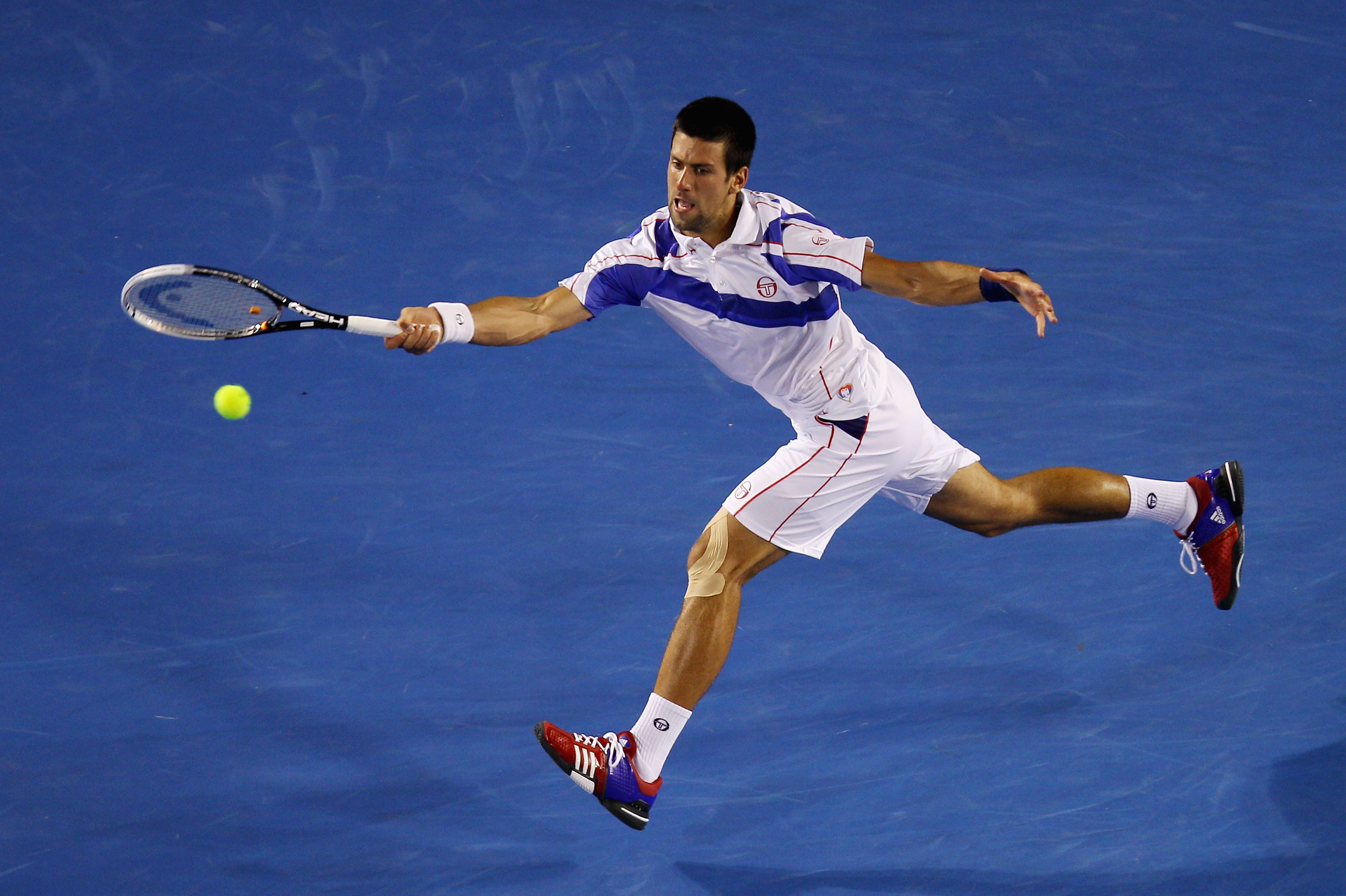 MELBOURNE, AUSTRALIA - JANUARY 30: Novak Djokovic of Serbia plays a forehand in his men's final match against Andy Murray of Great Britain during day fourteen of the 2011 Australian Open at Melbourne Park on January 30, 2011 in Melbourne, Australia. (Ph