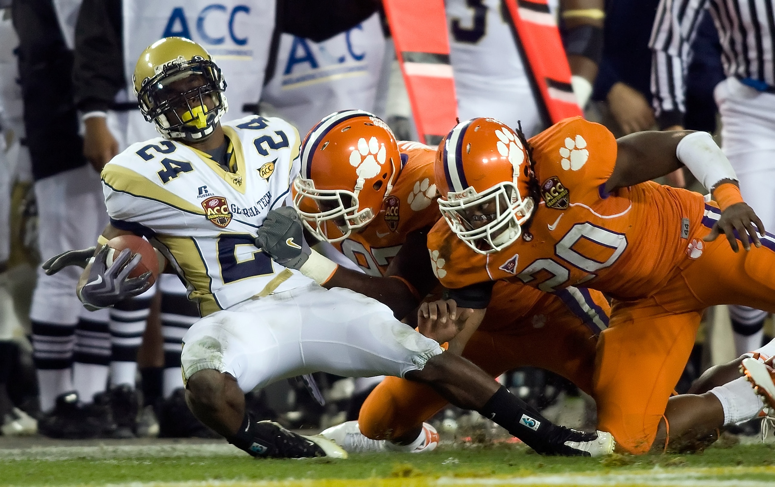 TAMPA - DECEMBER 05:  Defenders Mallicah Goodman #97 and Brandon Maye  #20 of the Clemson Tigers tackle running back Embry Peeples #24 of the Georgia Tech Yellow Jackets in the 2009 ACC Football Championship game at Raymond James Stadium on December 5, 20