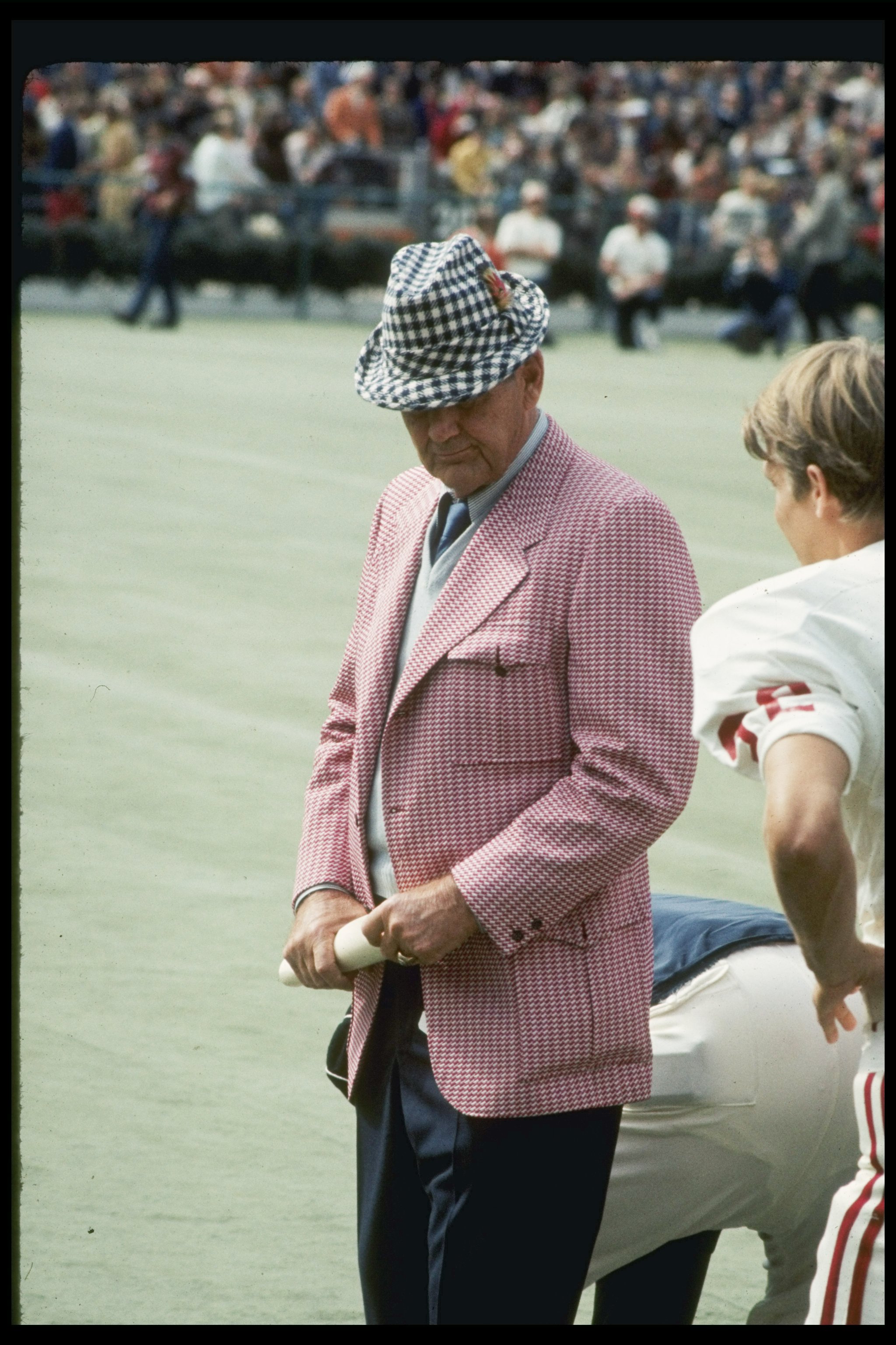 Coach Bear Bryant of the Alabama Crimson Tide watches his players during a game.