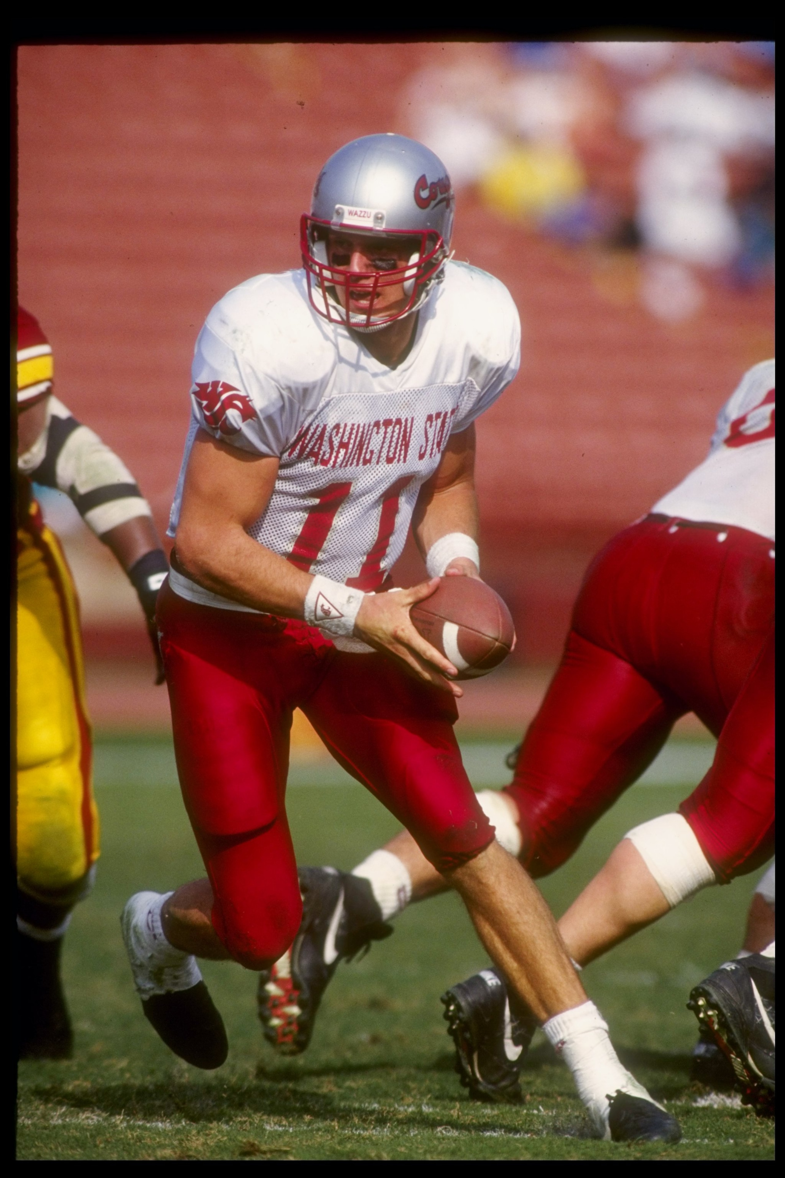 24 Oct 1994: Quarterback Drew Bledsoe of the Washington State Cougars scrambles with the ball during a game against the USC Trojans. USC won the game 31-21.