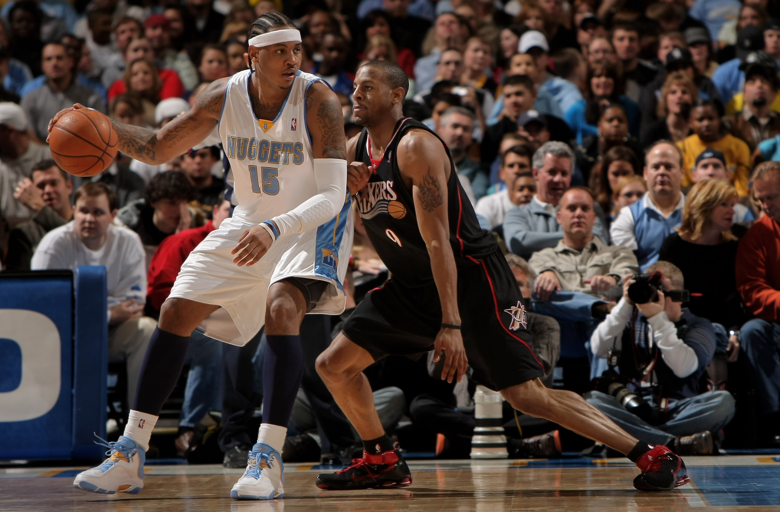 DENVER - JANUARY 6:  Carmelo Anthony #15 of the Denver Nuggets controls the ball as Andre Iguodala #9 of the Philadelphia 76ers defends at the Pepsi Center January 6, 2008 in Denver, Colorado. NOTE TO USER: User expressly acknowledges and agrees that, by
