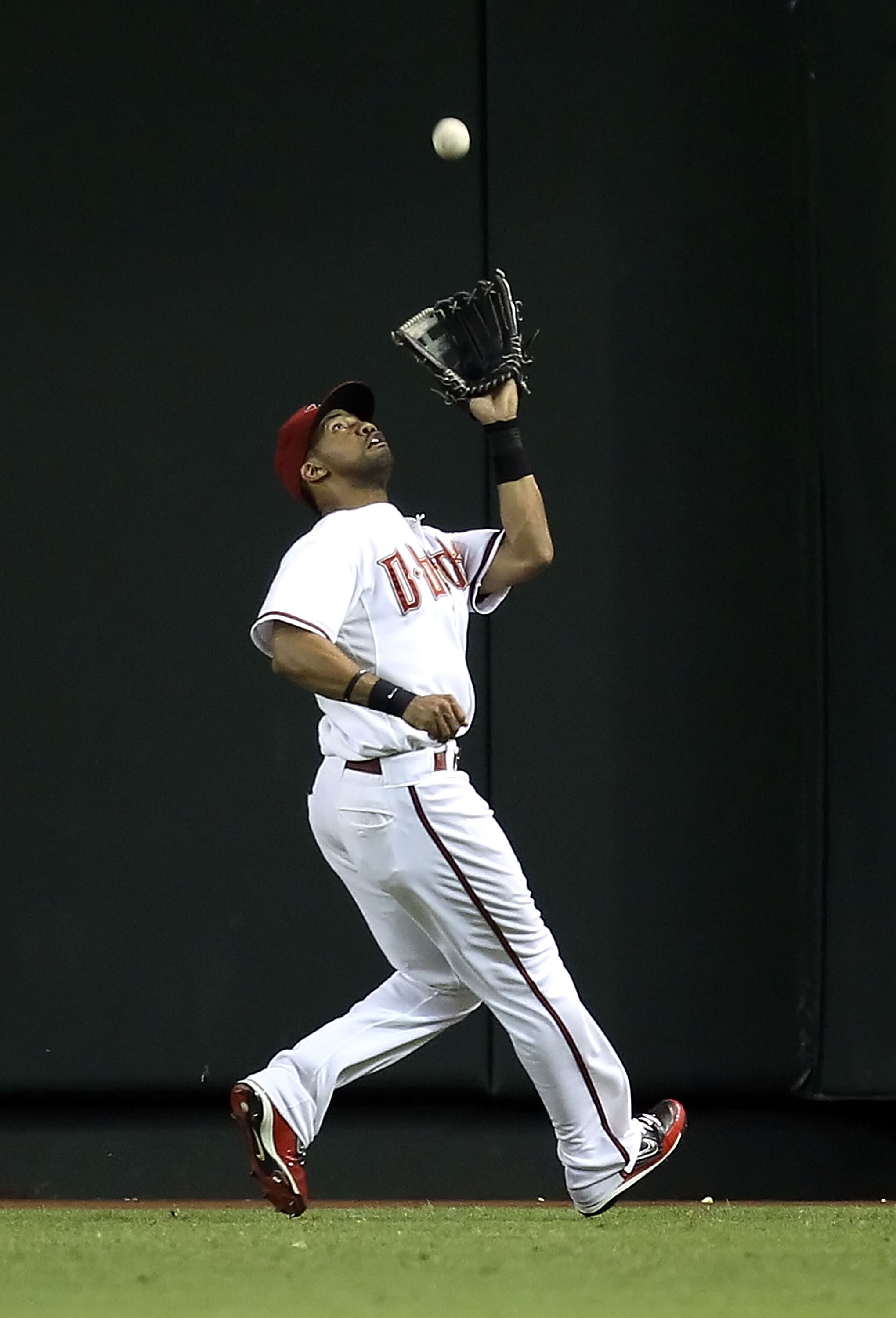 PHOENIX - SEPTEMBER 21:  Outfielder Chris Young #24 of the Arizona Diamondbacks catches a fly ball out against the Colorado Rockies during the Major League Baseball game at Chase Field on September 21, 2010 in Phoenix, Arizona.  (Photo by Christian Peters