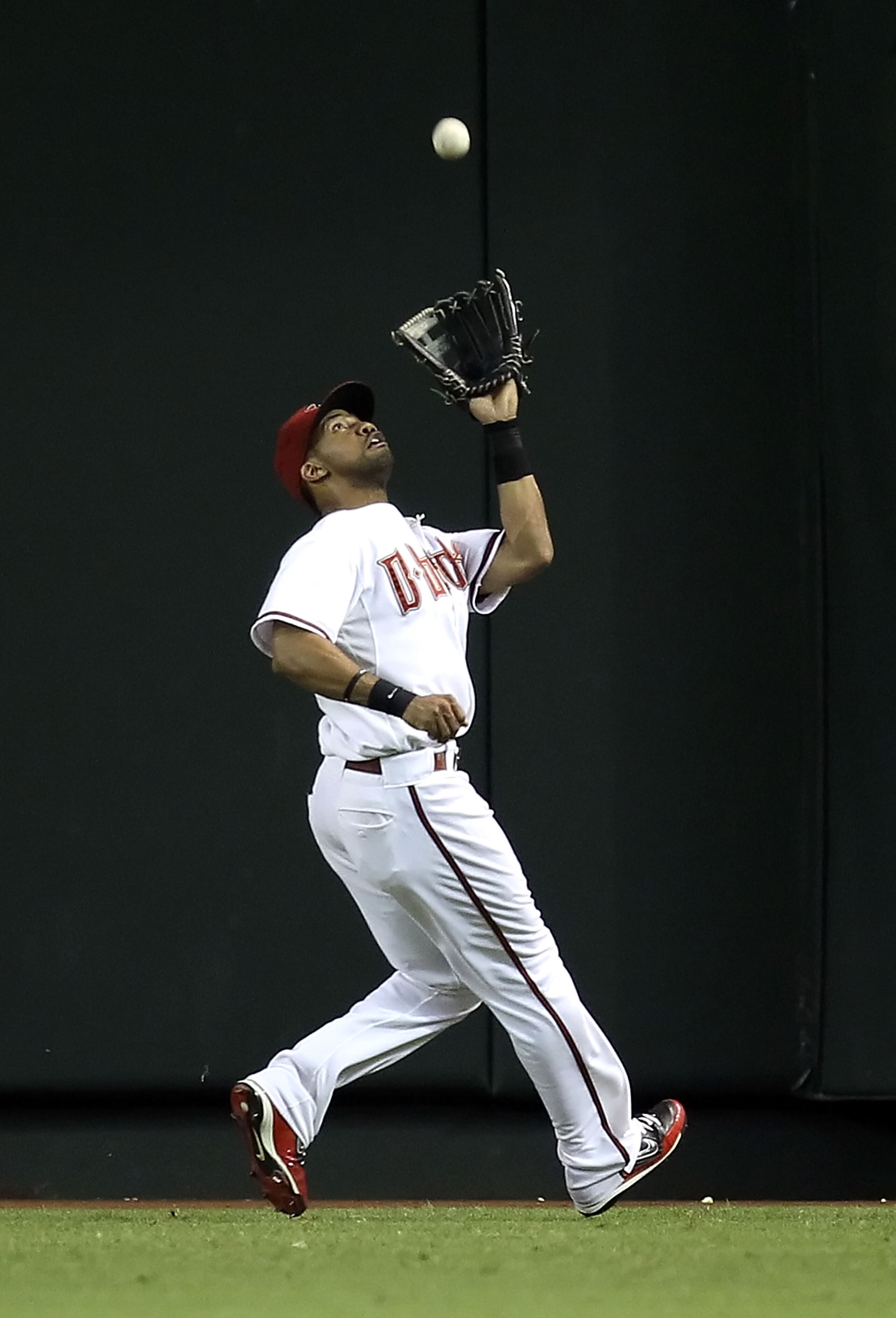 PHOENIX - SEPTEMBER 21:  Outfielder Chris Young #24 of the Arizona Diamondbacks catches a fly ball out against the Colorado Rockies during the Major League Baseball game at Chase Field on September 21, 2010 in Phoenix, Arizona.  (Photo by Christian Peters