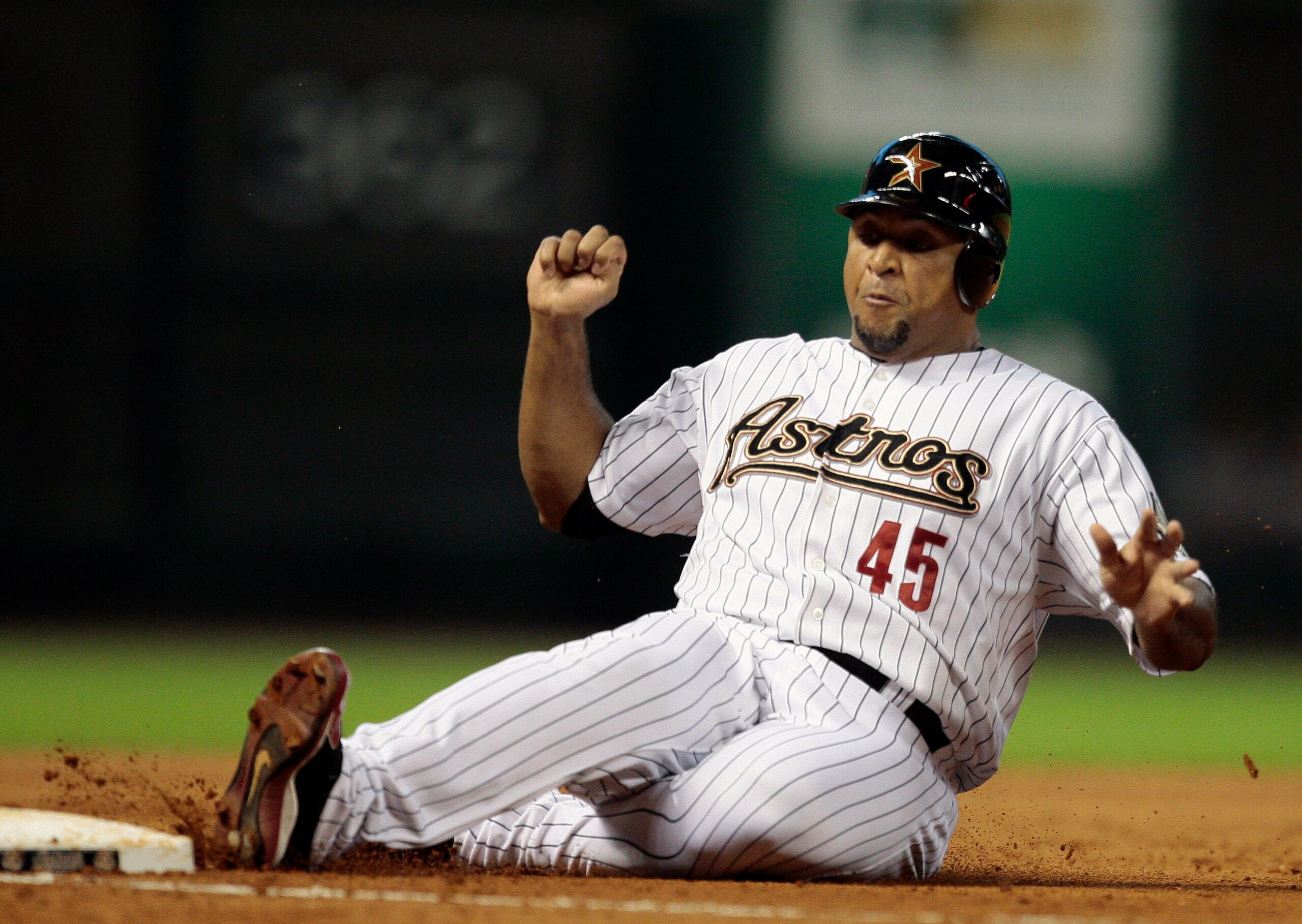 HOUSTON - JULY 09:  Carlos Lee #45 of the Houston Astros slides into third base during action against the St. Louis Cardinals at Minute Maid Park on July 9, 2010 in Houston, Texas.  (Photo by Bob Levey/Getty Images)