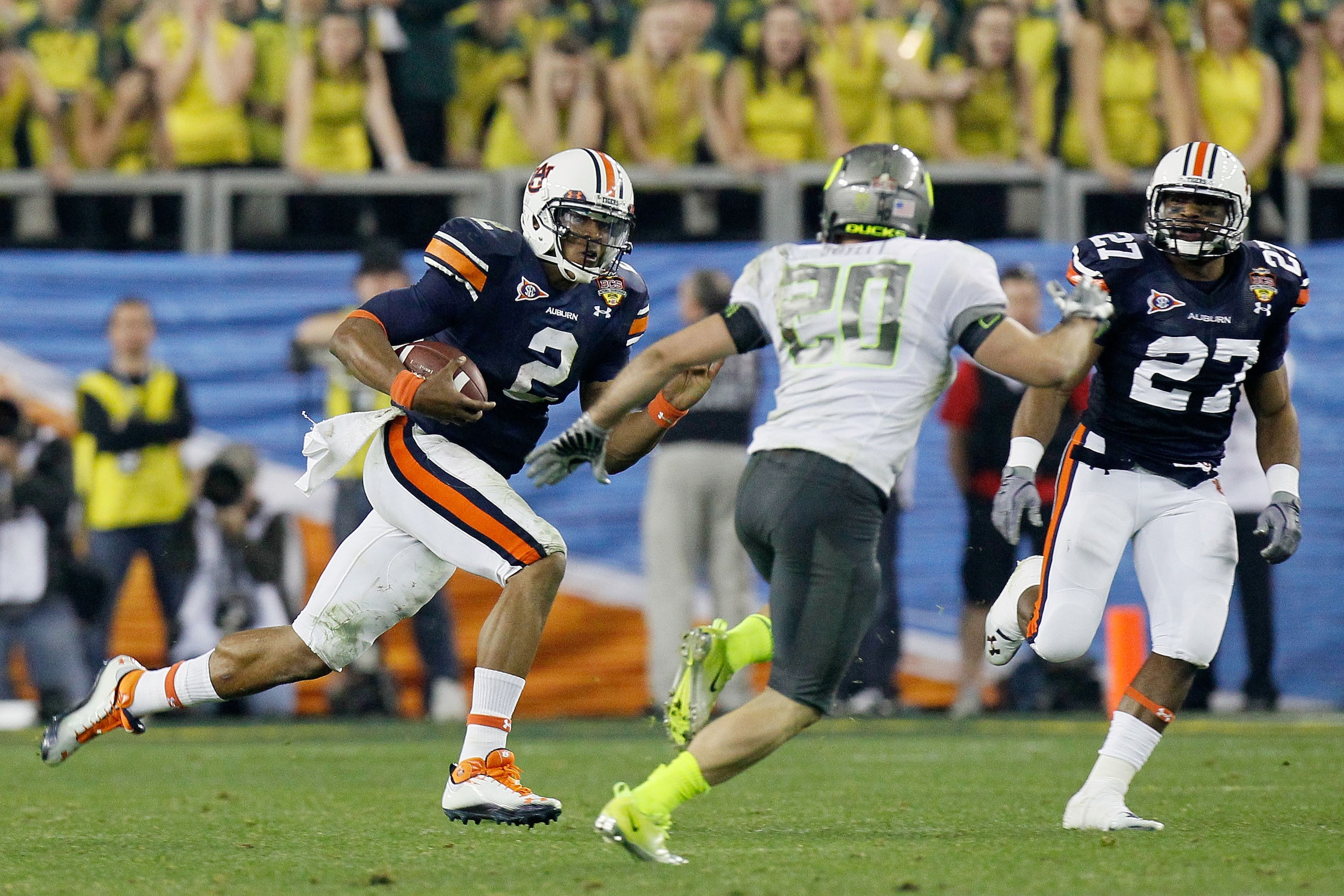 GLENDALE, AZ - JANUARY 10:  Cameron Newton #2 of the Auburn Tigers runs down field against John Boyett #20 of the Oregon Ducks during the Tostitos BCS National Championship Game at University of Phoenix Stadium on January 10, 2011 in Glendale, Arizona.  (