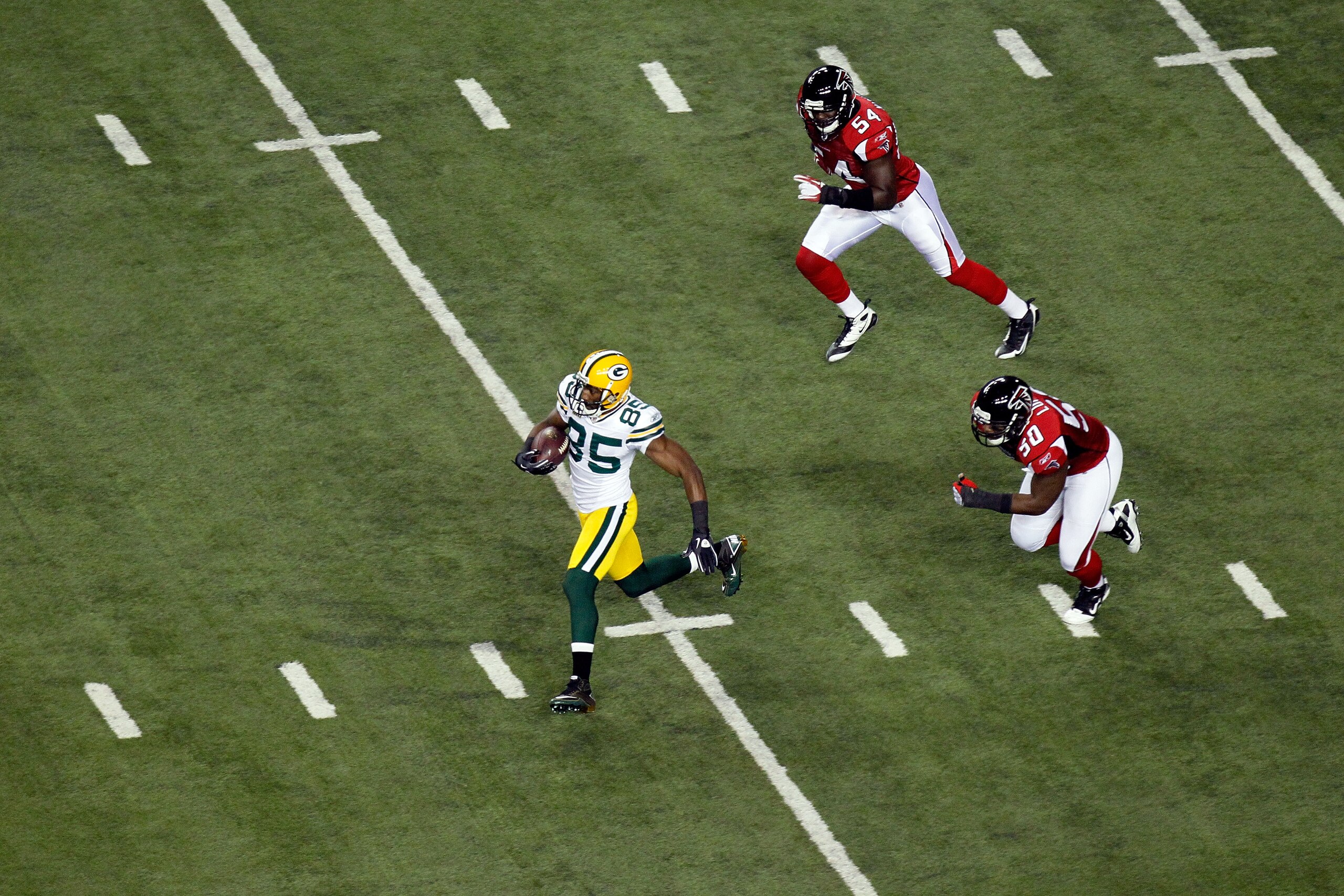 ATLANTA, GA - JANUARY 15: Greg Jenning #85 of the Green Bay Packers runs for yards after the catch against the Atlanta Falcons during their 2011 NFC divisional playoff game at Georgia Dome on January 15, 2011 in Atlanta, Georgia. The Packers won 48-21. ( ATLANTA, GA - JANUARY 15: Greg Jenning #85 of the Green Bay Packers runs for yards after the catch against the Atlanta Falcons during their 2011 NFC divisional playoff game at Georgia Dome on January 15, 2011 in Atlanta, Georgia. The Packers won 48-21. (