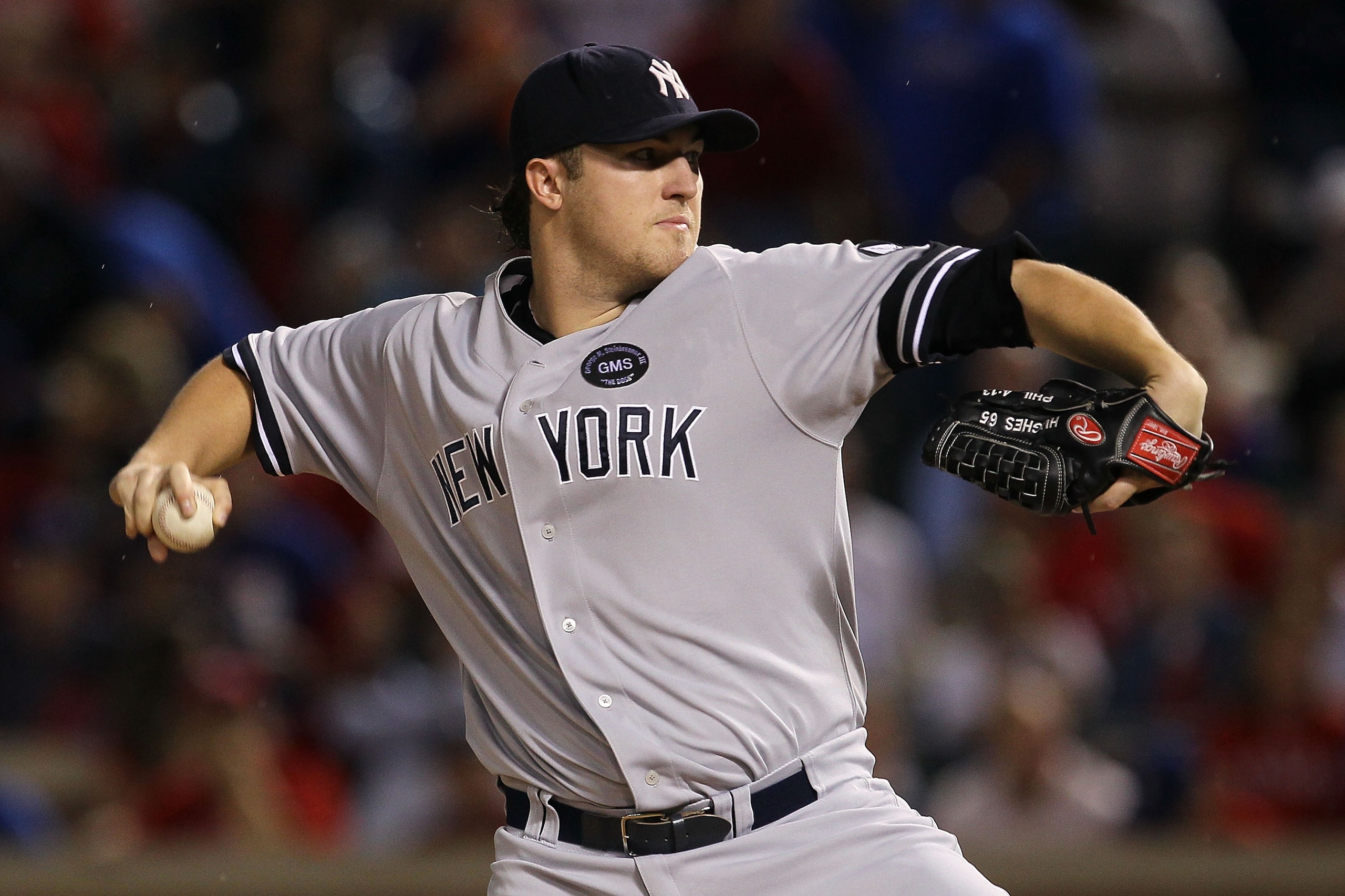 ARLINGTON, TX - OCTOBER 22:  Phil Hughes #65 of the New York Yankees throws a pitch against the New York Yankees in Game Six of the ALCS during the 2010 MLB Playoffs at Rangers Ballpark in Arlington on October 22, 2010 in Arlington, Texas.  (Photo by Step