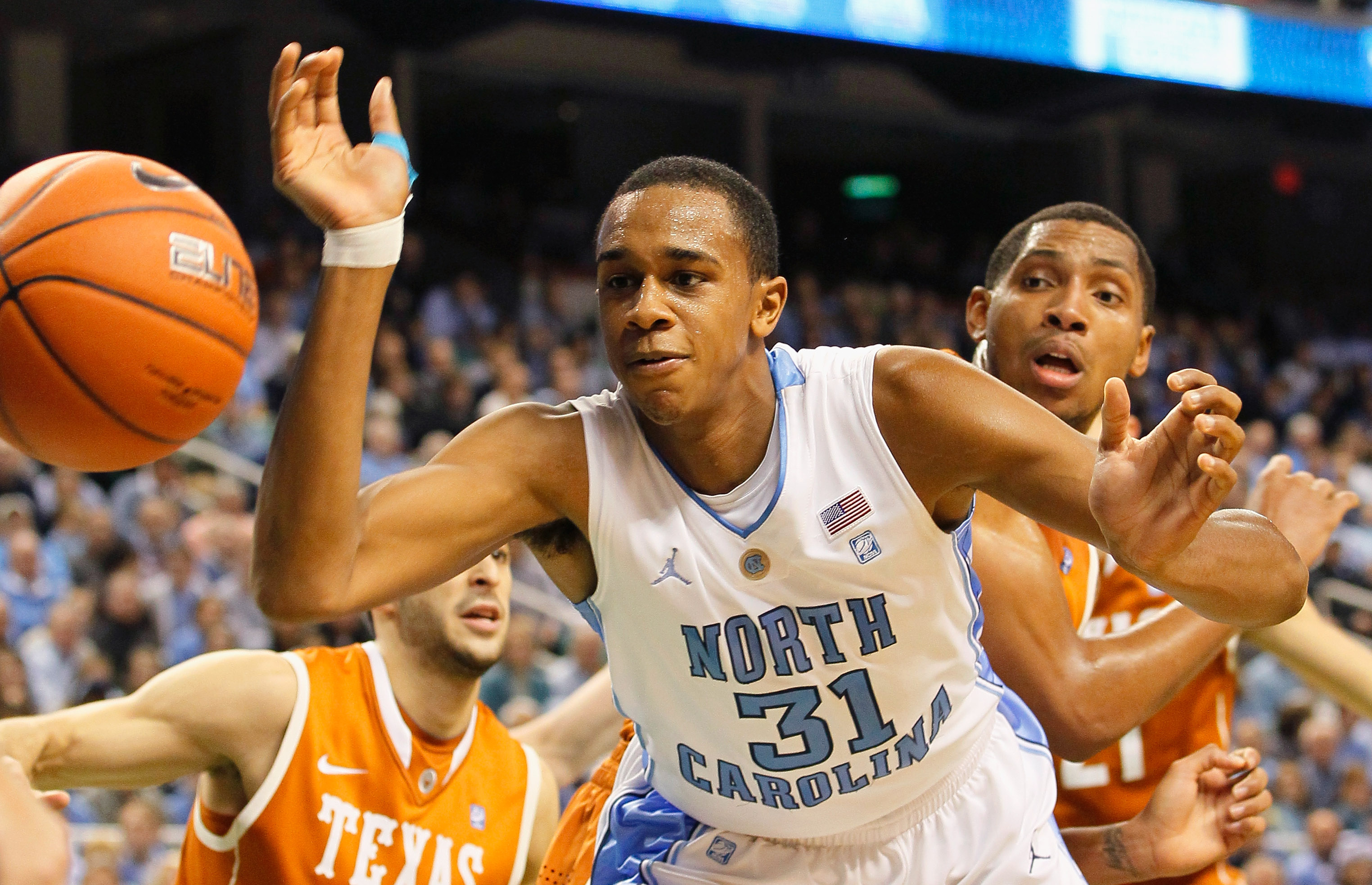 GREENSBORO, NC - DECEMBER 18:  John Henson #31 of the North Carolina Tar Heels has the ball stripped by Gary Johnson #1 of the Texas Longhorns at Greensboro Coliseum on December 18, 2010 in Greensboro, North Carolina.  (Photo by Kevin C. Cox/Getty Images)