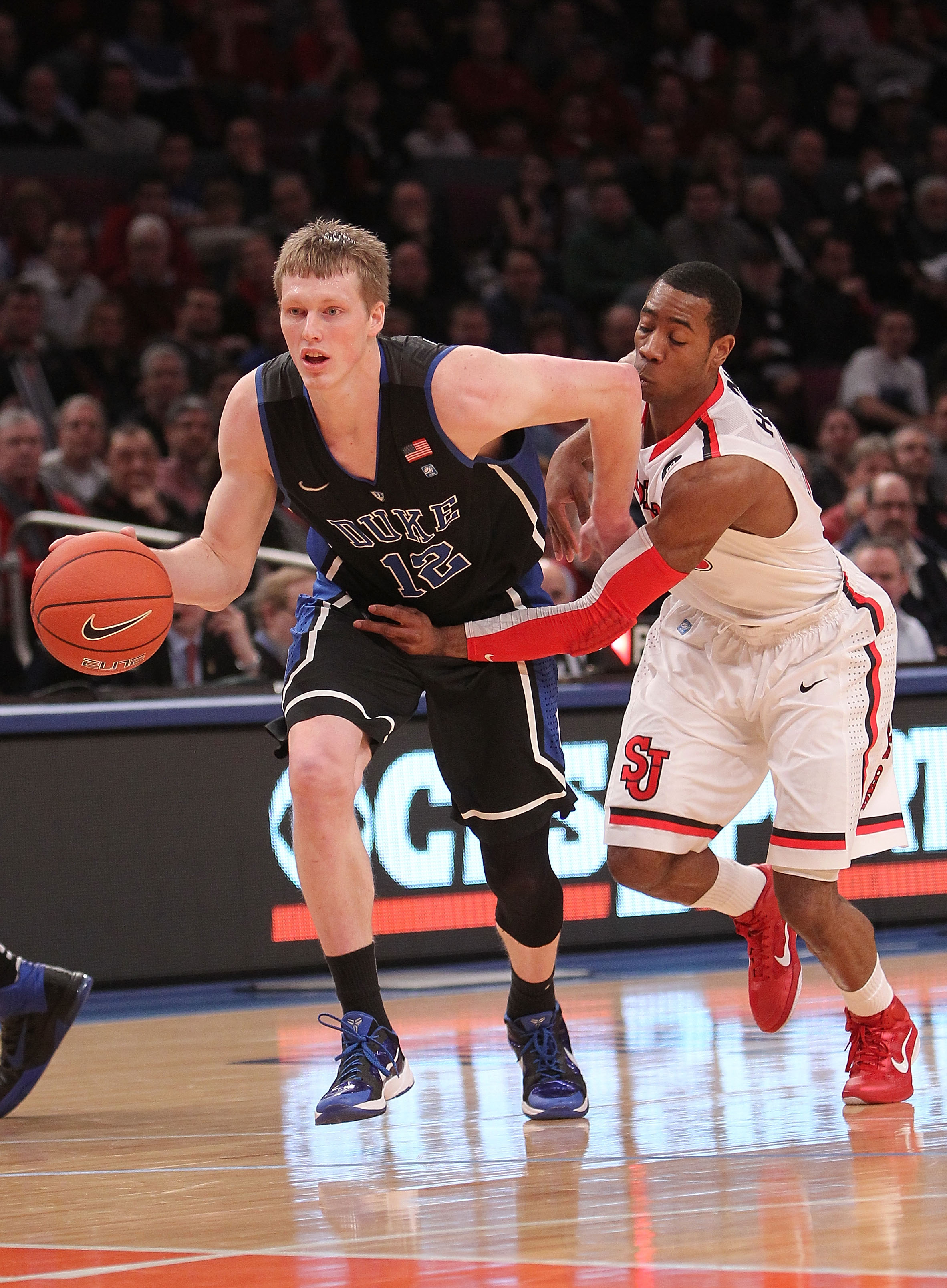 NEW YORK, NY - JANUARY 30:  Kyle Singler #12 of the Duke Blue Devils dribbles the ball past Paris Horne #23 of the St. John's Red Storm at Madison Square Garden on January 30, 2011 in New York City.  (Photo by Nick Laham/Getty Images)
