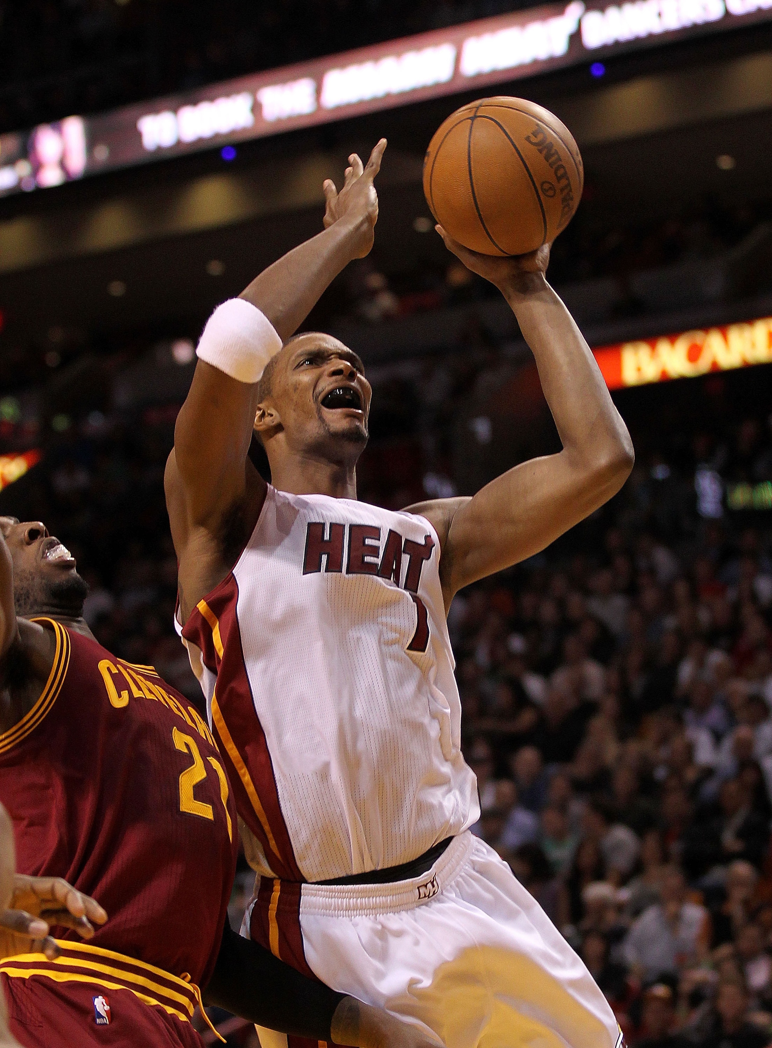 MIAMI, FL - JANUARY 31: Chris Bosh #1 of the Miami Heat takes a shot during a game against the Cleveland Cavaliers at American Airlines Arena on January 31, 2011 in Miami, Florida. NOTE TO USER: User expressly acknowledges and agrees that, by downloading MIAMI, FL - JANUARY 31: Chris Bosh #1 of the Miami Heat takes a shot during a game against the Cleveland Cavaliers at American Airlines Arena on January 31, 2011 in Miami, Florida. NOTE TO USER: User expressly acknowledges and agrees that, by downloading