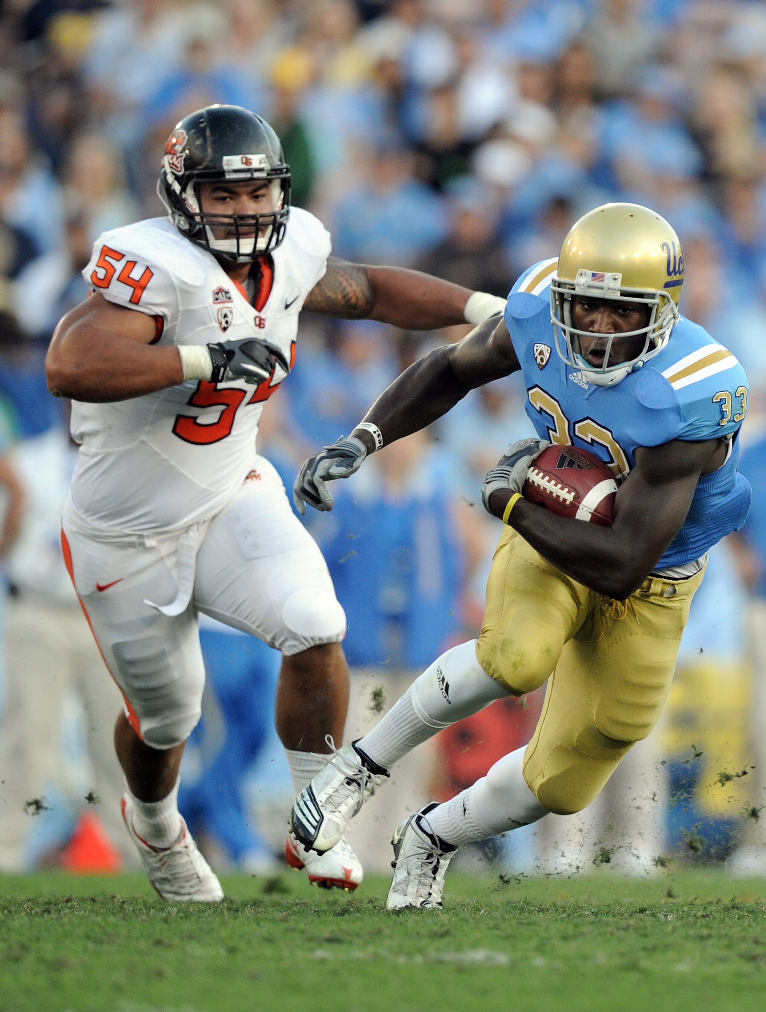 PASADENA, CA - NOVEMBER 06:  Derrick Coleman #33 of the UCLA Bruins runs away from Stephen Paea #54 of the Oregon State Beavers during the second quarter at the Rose Bowl on November 6, 2010 in Pasadena, California.  (Photo by Harry How/Getty Images)