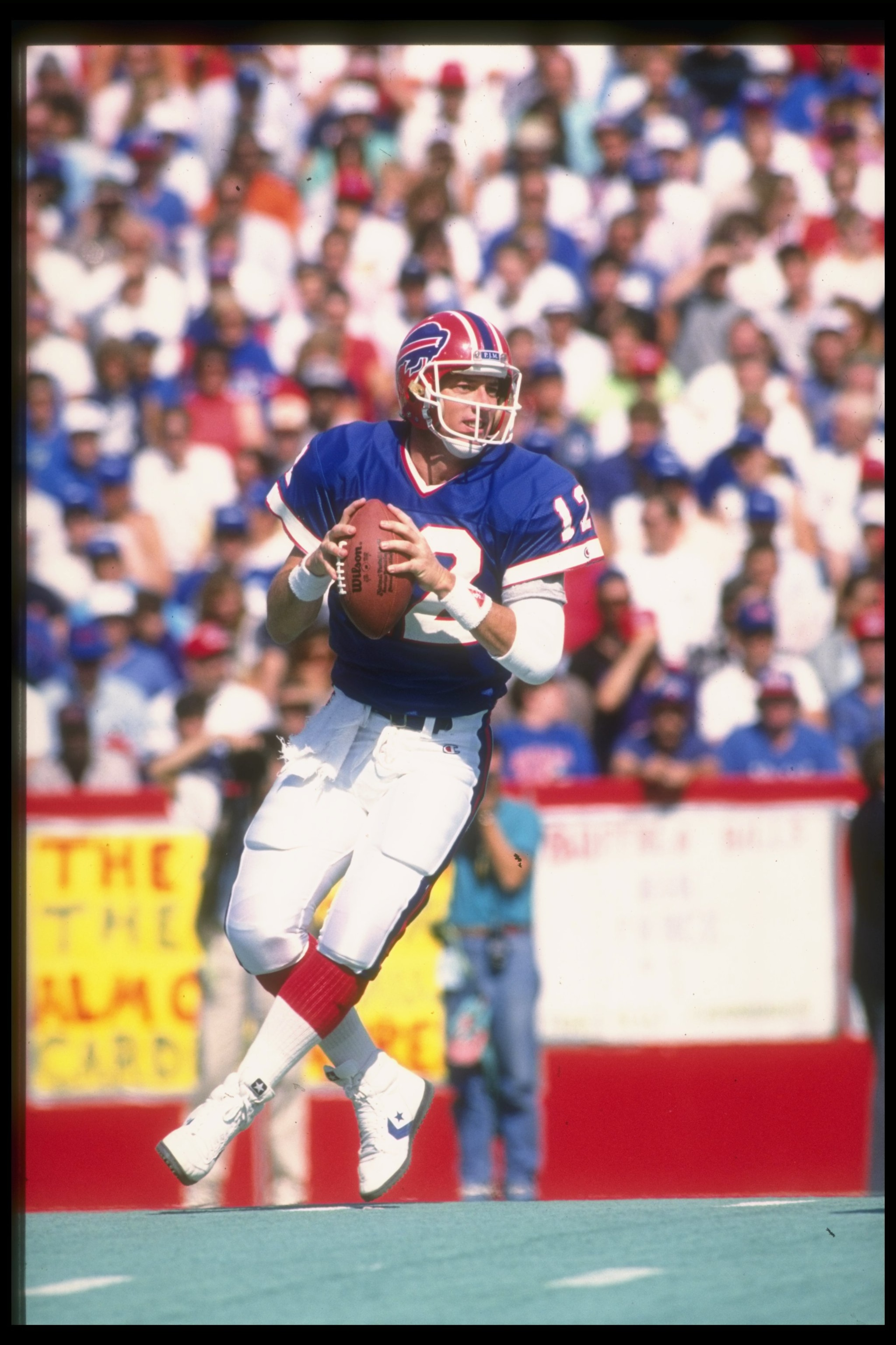 1989-1990:  Quarterback Jim Kelly of the Buffalo Bills looks to pass the ball during a game against the New England Patriots at Rich Stadium in Orchard Park, New York.  The Bills won the game, 31-10. Mandatory Credit: Rick Stewart  /Allsport
