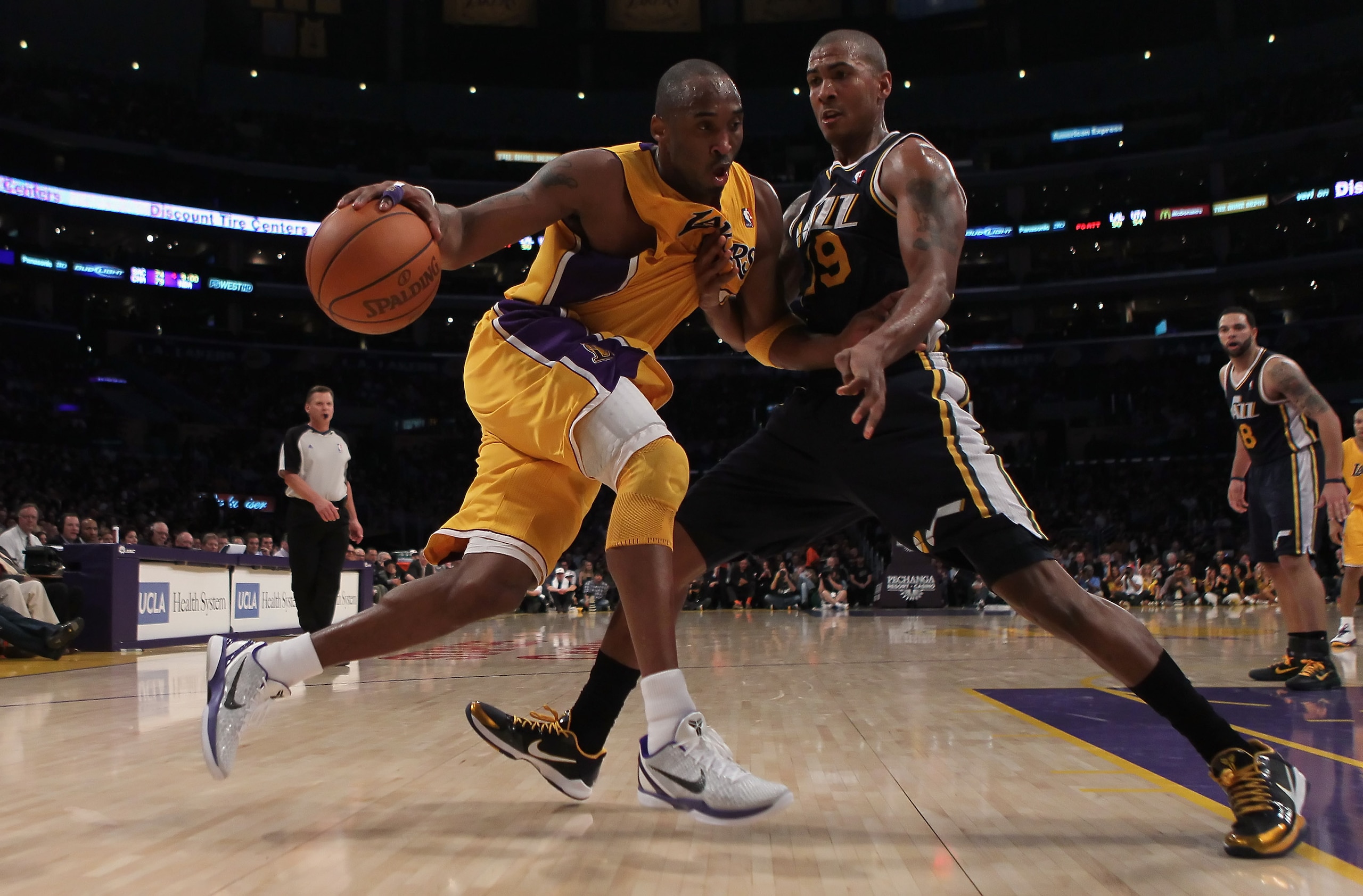 LOS ANGELES, CA - JANUARY 25:  Kobe Bryant #24 of the Los Angeles Lakers drives to the basket while being defended by Raja Bell #19 of the Utah Jazz in the second half at Staples Center on January 25, 2011 in Los Angeles, California. The Lakers defeated t