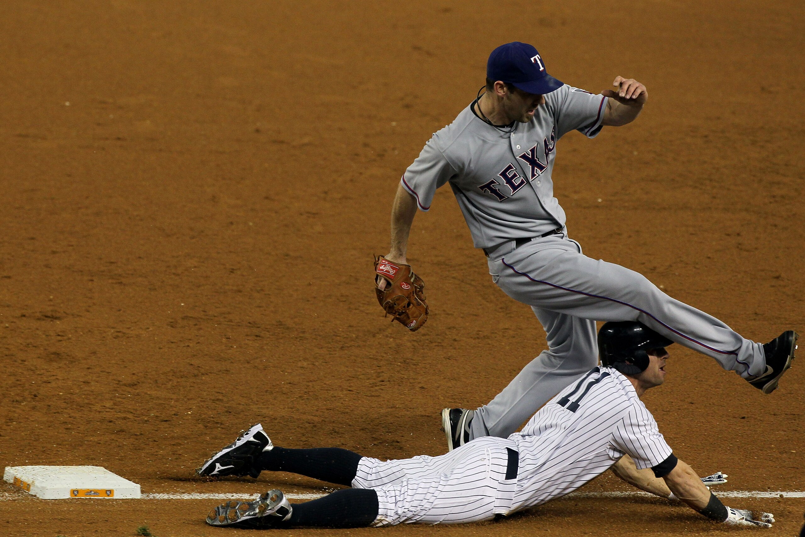 NEW YORK - OCTOBER 18:  Brett Gardner #11 of the New York Yankees is forced out at first base by pitcher Cliff Lee #33 of the Texas Rangers in the bottom of the third inning of Game Three of the ALCS during the 2010 MLB Playoffs at Yankee Stadium on Octob