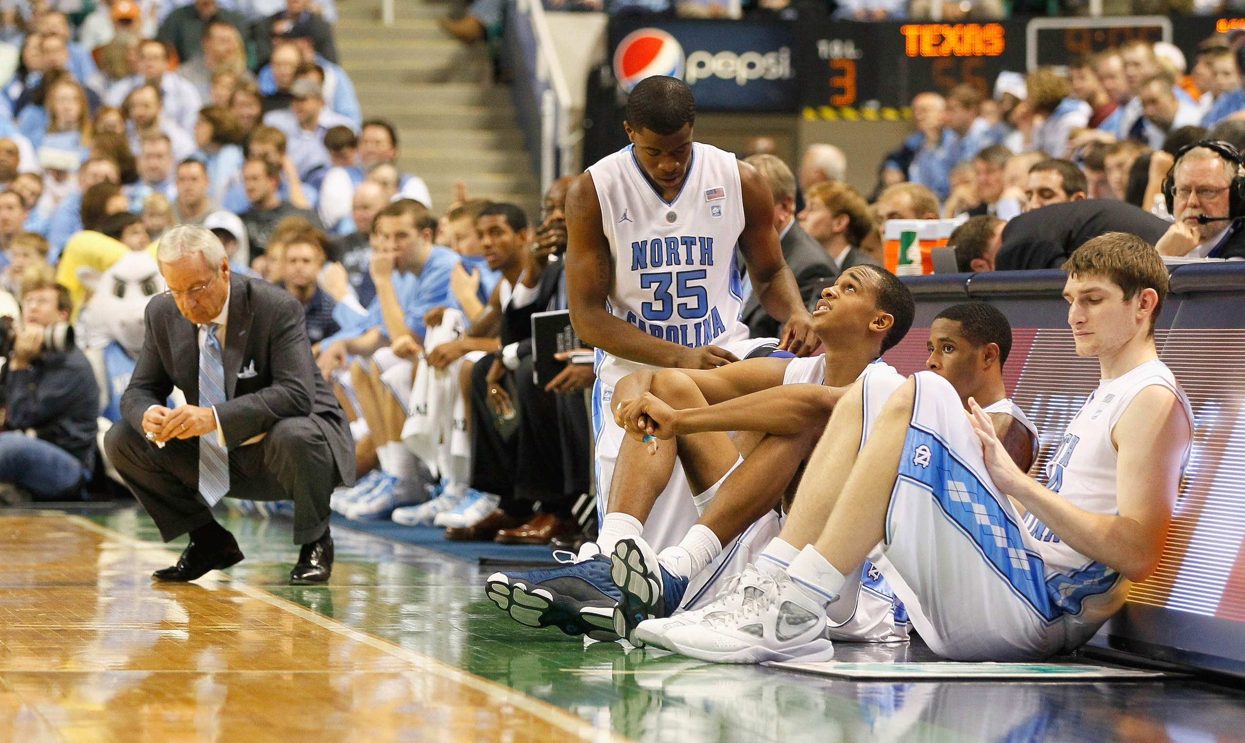 GREENSBORO, NC - DECEMBER 18:  Reggie Bullock #35, John Henson #31, Larry Drew II #11 and Tyler Zeller #44 of the North Carolina Tar Heels wait to enter the game as head coach Roy Williams reacts to a basket by the Texas Longhorns at Greensboro Coliseum o
