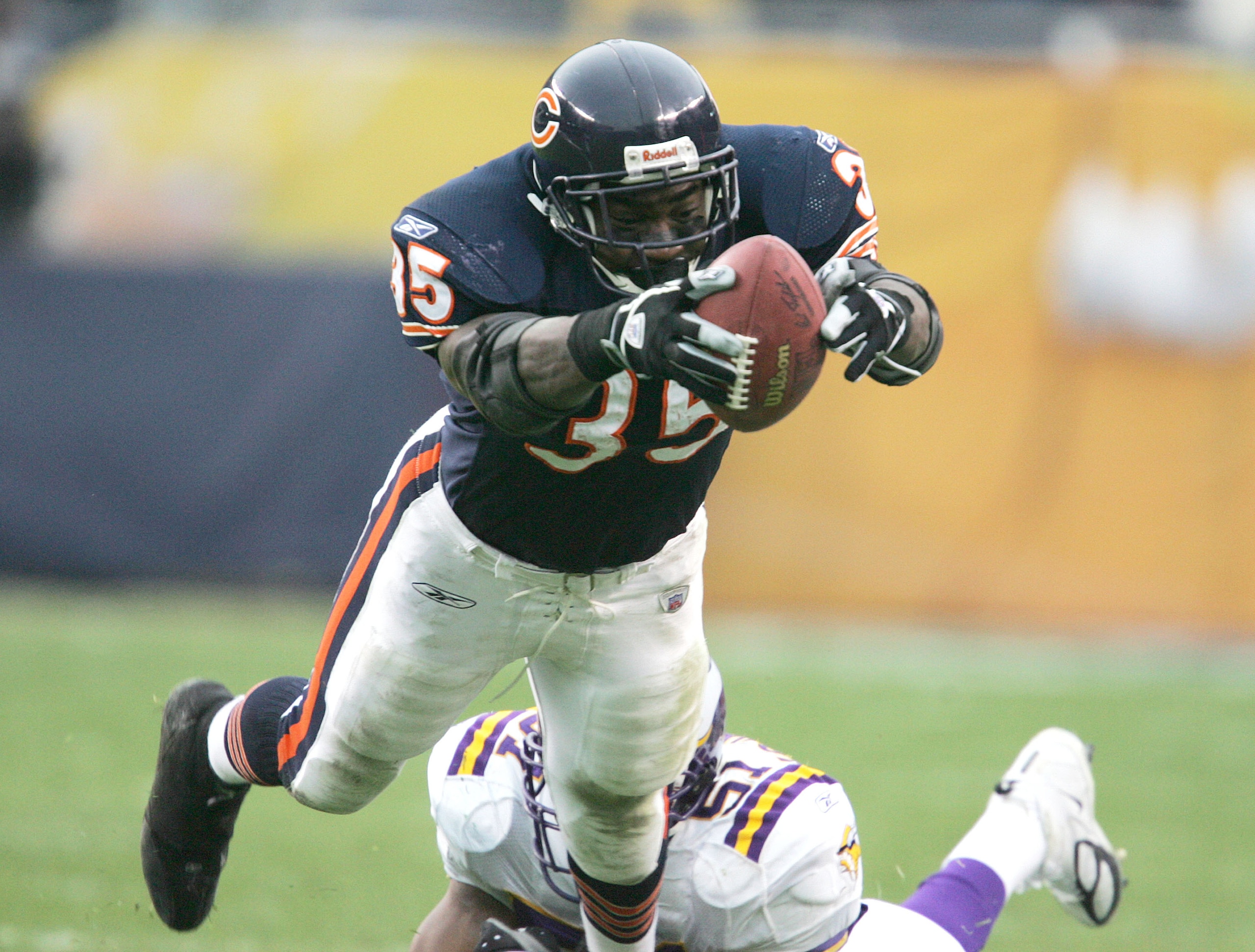 CHICAGO - DECEMBER 5: Anthony Thomas #35 of the Chicago Bears lunges for a first down as Lance Johnstone #51 of the Minnesota Vikings defends December 5, 2004 at Soldier Field in Chicago, Illinois. The Bears defeated the Vikings 24-14. (Photo by Jonathan
