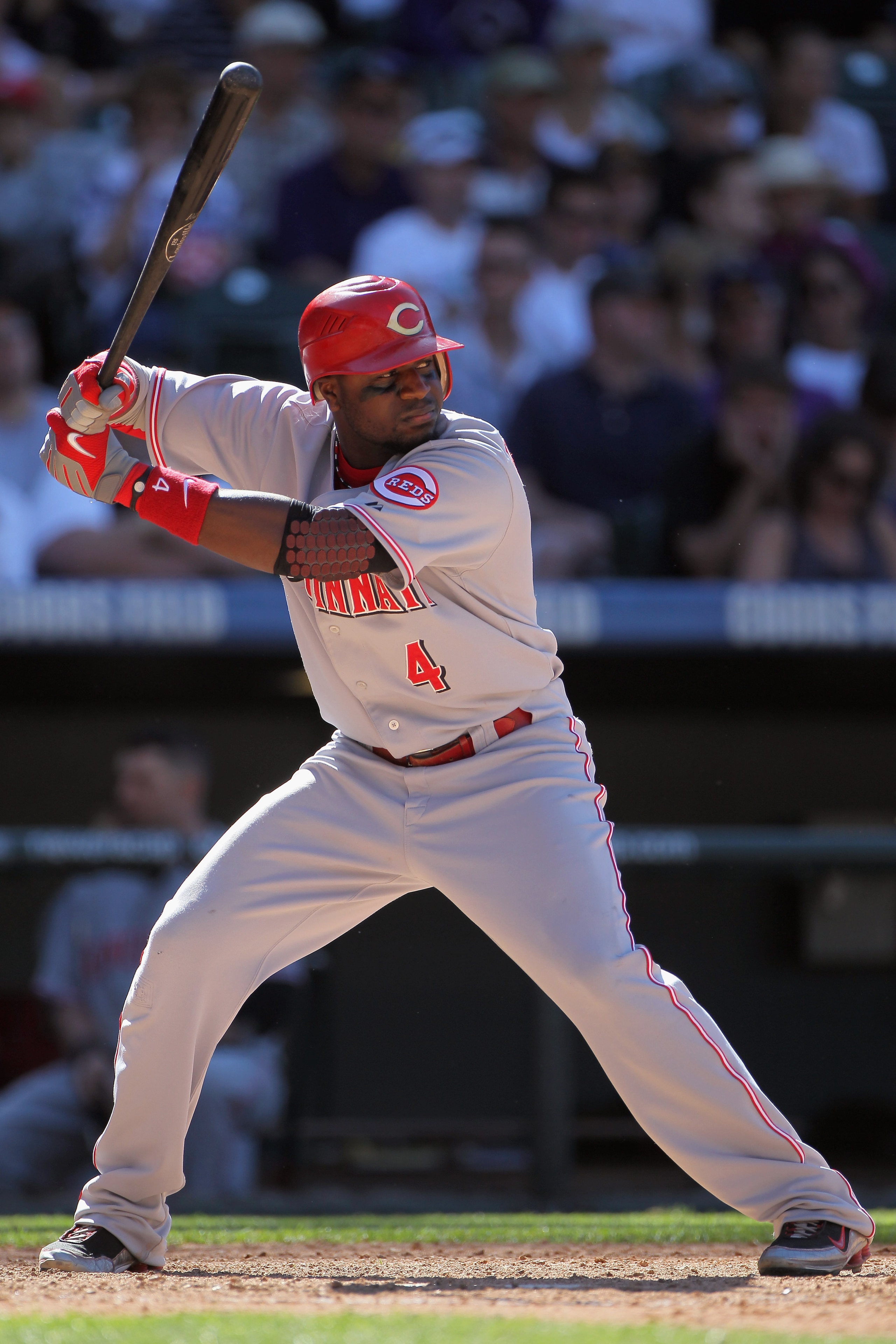 DENVER - SEPTEMBER 06: Second baseman Brandon Phillips #4 of the Cincinnati Reds takes an at bat against the Colorado Rockies at Coors Field on September 6, 2010 in Denver, Colorado. The Rockies defeated the Reds 10-5. (Photo by Doug Pensinger/Getty Ima DENVER - SEPTEMBER 06: Second baseman Brandon Phillips #4 of the Cincinnati Reds takes an at bat against the Colorado Rockies at Coors Field on September 6, 2010 in Denver, Colorado. The Rockies defeated the Reds 10-5. (Photo by Doug Pensinger/Getty Ima