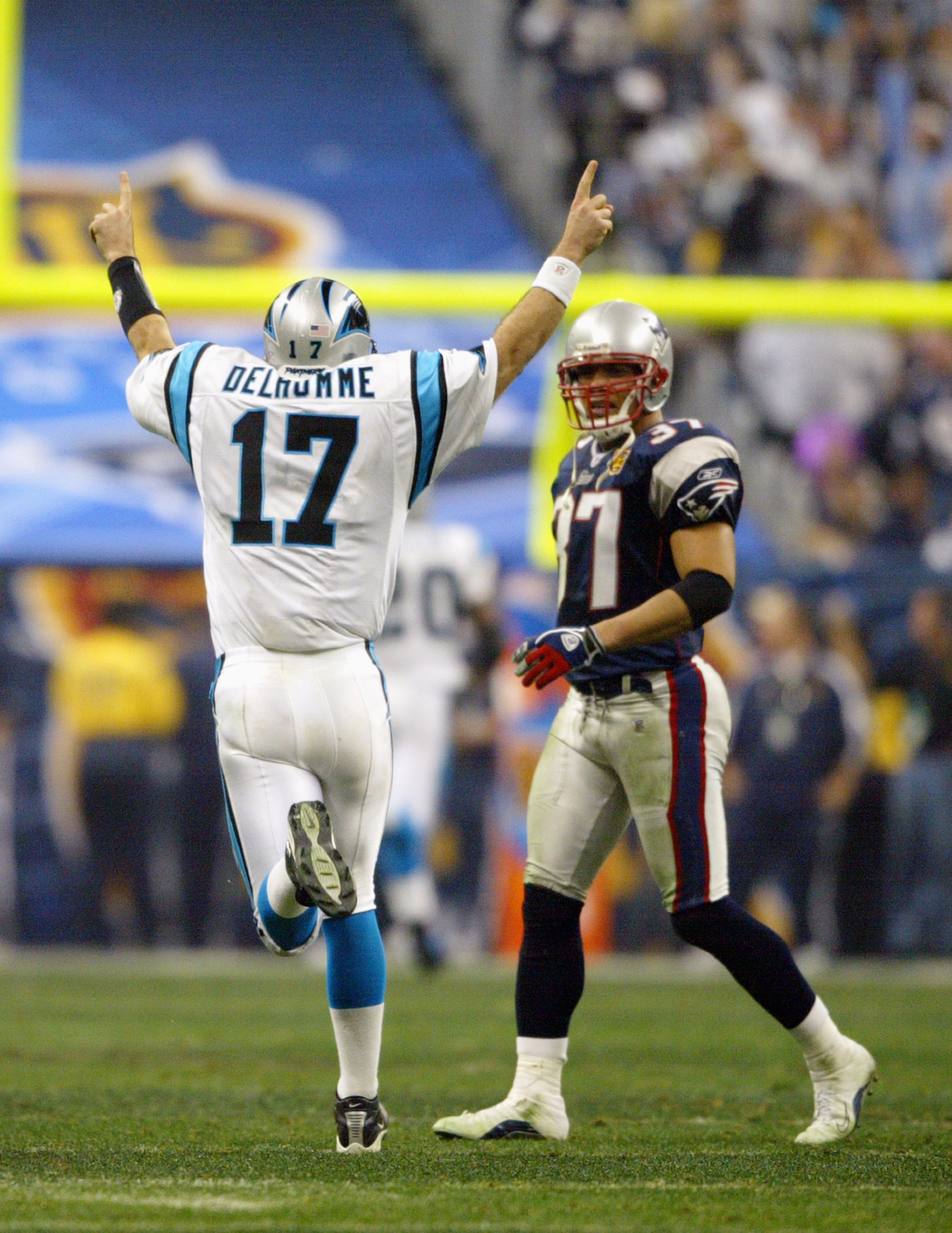HOUSTON - FEBRUARY 1:  Quarterback Jake Delhomme #17 of the Carolina Panthers celebrates a play as Jarvis Green #97 of the New England Patriots looks on during Super Bowl XXXVIII at Reliant Stadium on February 1, 2004 in Houston, Texas.  The Patriots defe