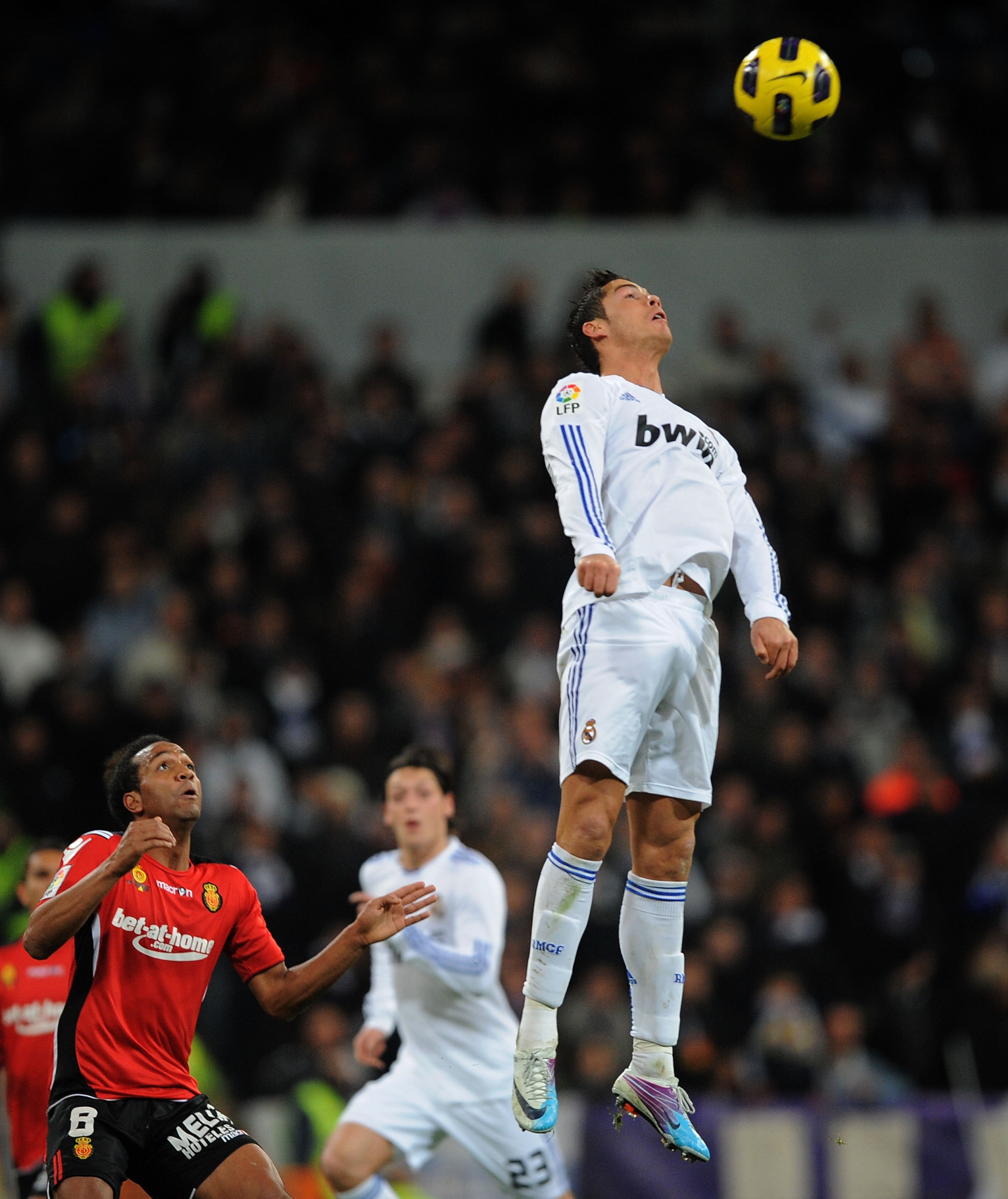 MADRID, SPAIN - JANUARY 23: Cristiano Ronaldo (R) of Real Madrid goes for a high ball as Emilio Nsue of Mallorca looks on during the La Liga match between Real Madrid and Mallorca at Estadio Santiago Bernabeu on January 23, 2011 in Madrid, Spain. (Photo MADRID, SPAIN - JANUARY 23: Cristiano Ronaldo (R) of Real Madrid goes for a high ball as Emilio Nsue of Mallorca looks on during the La Liga match between Real Madrid and Mallorca at Estadio Santiago Bernabeu on January 23, 2011 in Madrid, Spain. (Photo