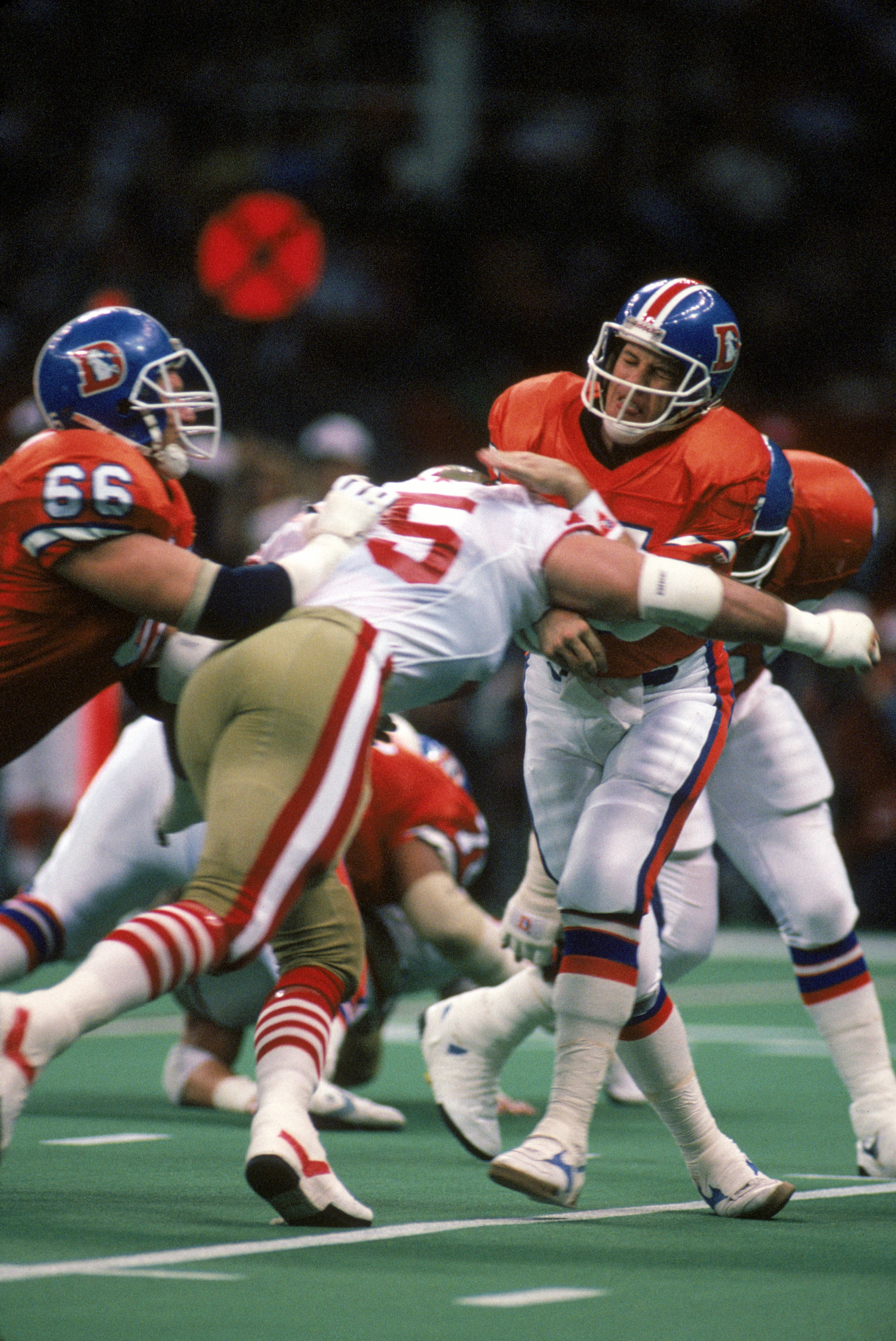 NEW ORLEANS - JANUARY 28:  Third and ten at the San Francisco 49ers twenty five yard line, Quarterback John Elway #7 of the Denver Broncos gets hit as he misses a pass intended for wide receiver Mark Jackson, the Broncos settle for a field goal during Sup