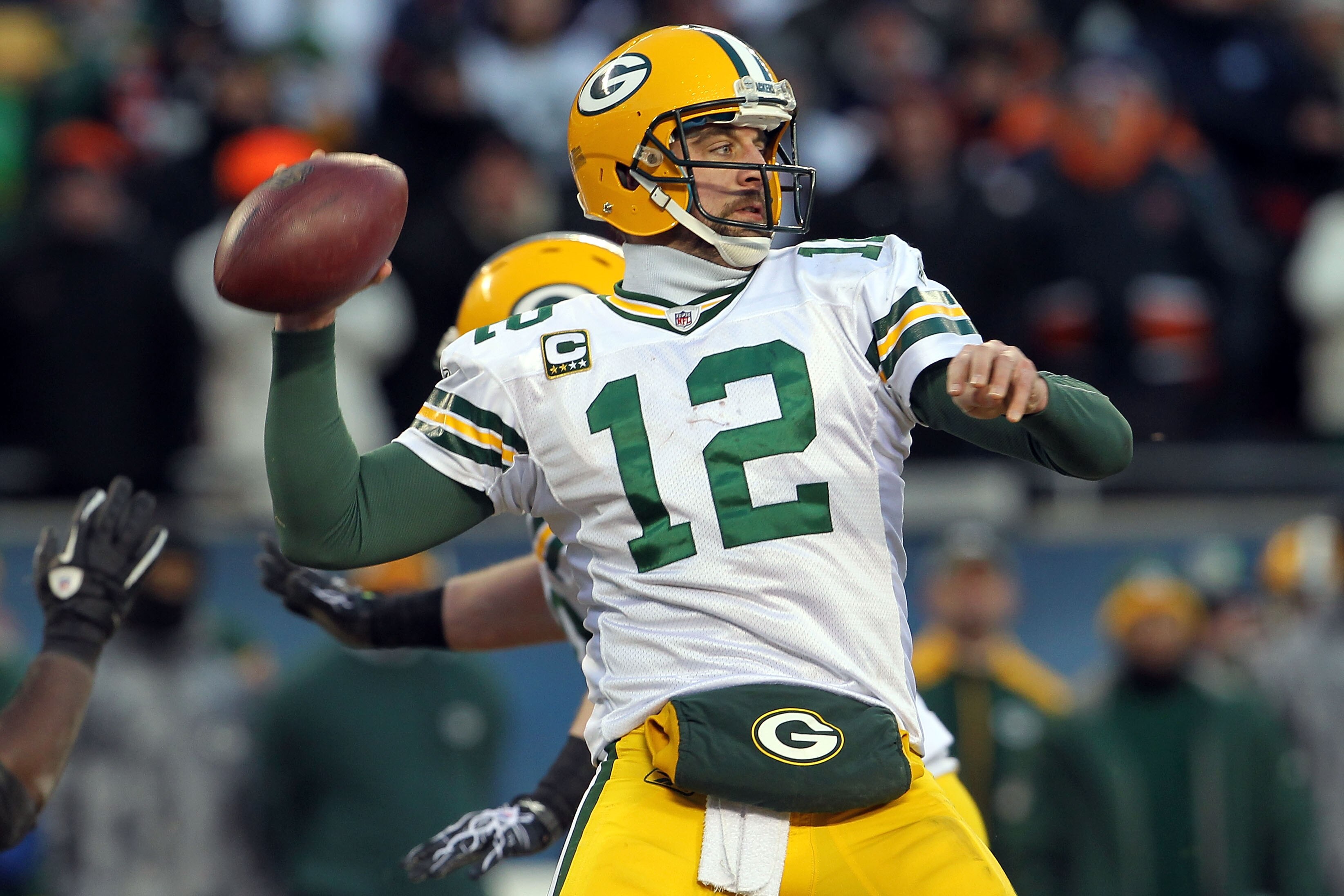 CHICAGO, IL - JANUARY 23:  Quarterback Aaron Rodgers #12 of the Green Bay Packers looks to pass against the Chicago Bears in the NFC Championship Game at Soldier Field on January 23, 2011 in Chicago, Illinois.  (Photo by Jamie Squire/Getty Images)