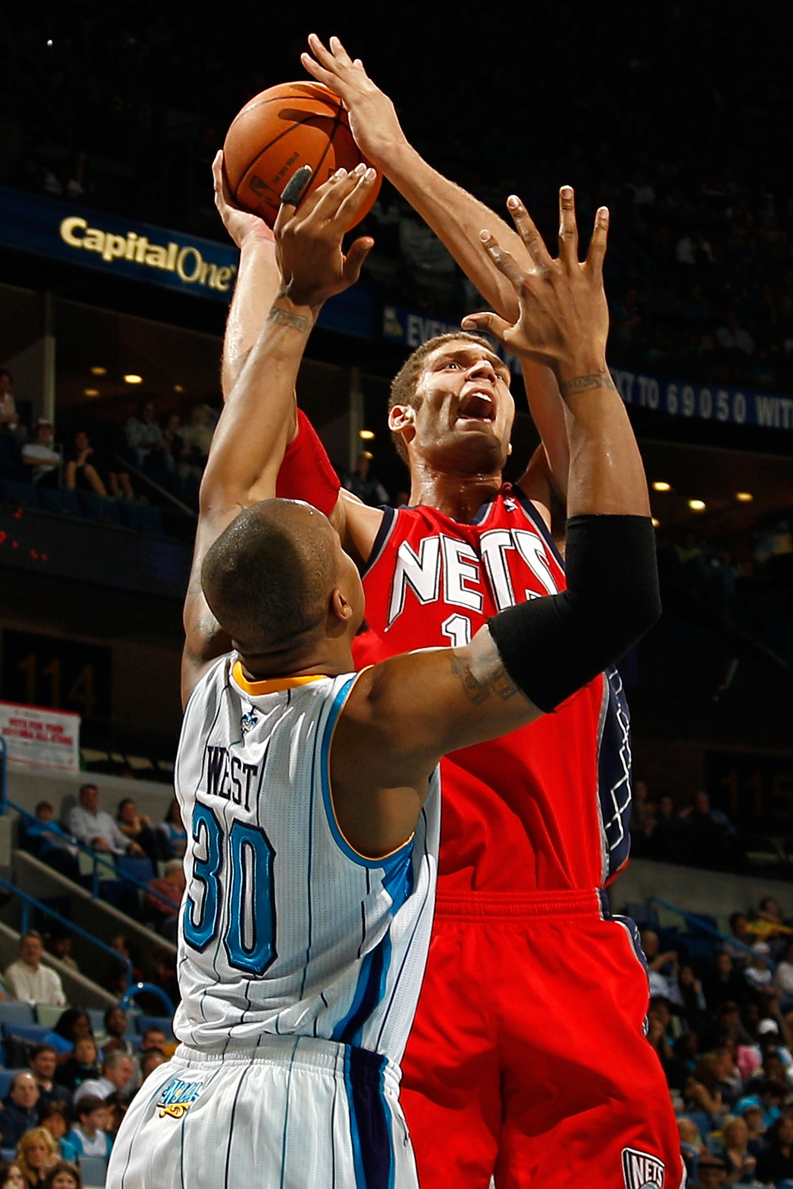 NEW ORLEANS, LA - DECEMBER 22:  Brook Lopez #11 of the New Jersey Nets shoots the ball over David West #30 of the New Orleans Hornets at the New Orleans Arena on December 22, 2010 in New Orleans, Louisiana.    The Hornets defeated the Nets 105-91.   NOTE