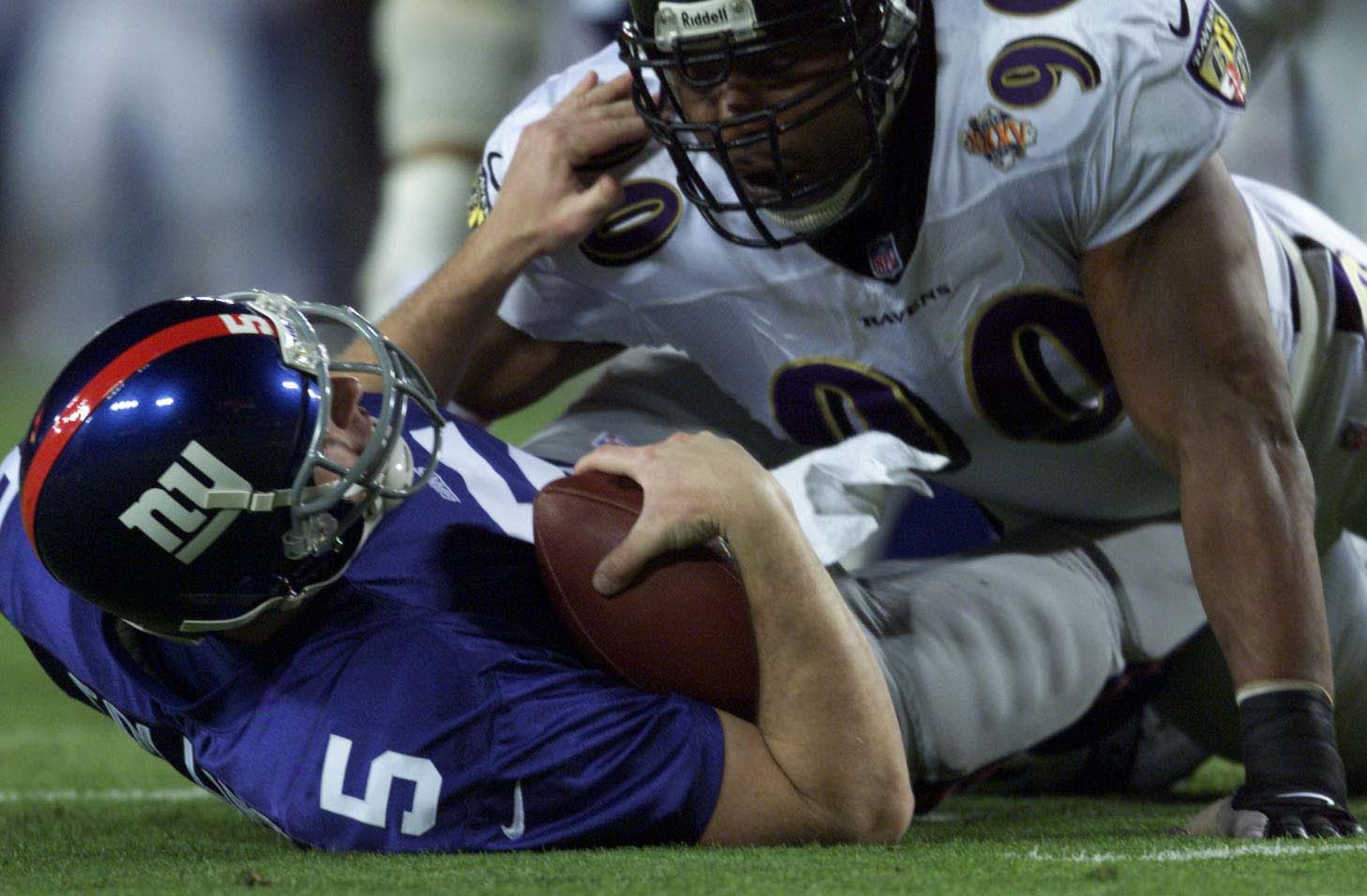 28 Jan 2001:  Kerry Collins #5 of the New York Giants is sacked by Rob Burnett #90 of the Baltimore ravens during Super Bowl XXXV at Raymond James Stadium in Tampa, Florida.  DIGITAL IMAGE. Mandatory Credit: Brian Bahr/ALLSPORT