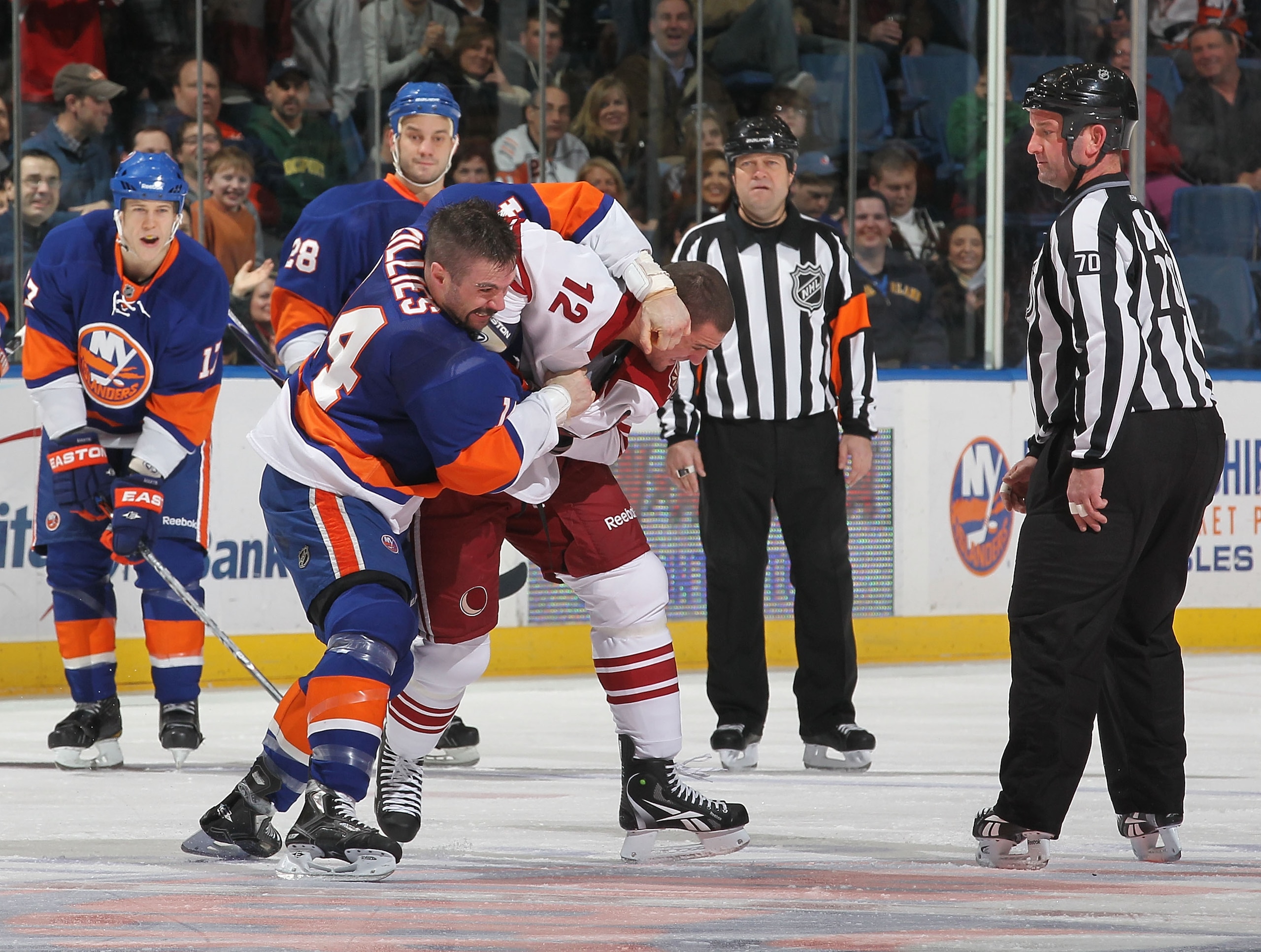 UNIONDALE, NY - DECEMBER 18:  Trevor Gillies #14 of the New York Islanders fights Paul Bissonnette #12 of the Phoenix Coyotes during their game on December 18, 2010 at the Nassau Coliseum in Uniondale, New York.  (Photo by Al Bello/Getty Images)