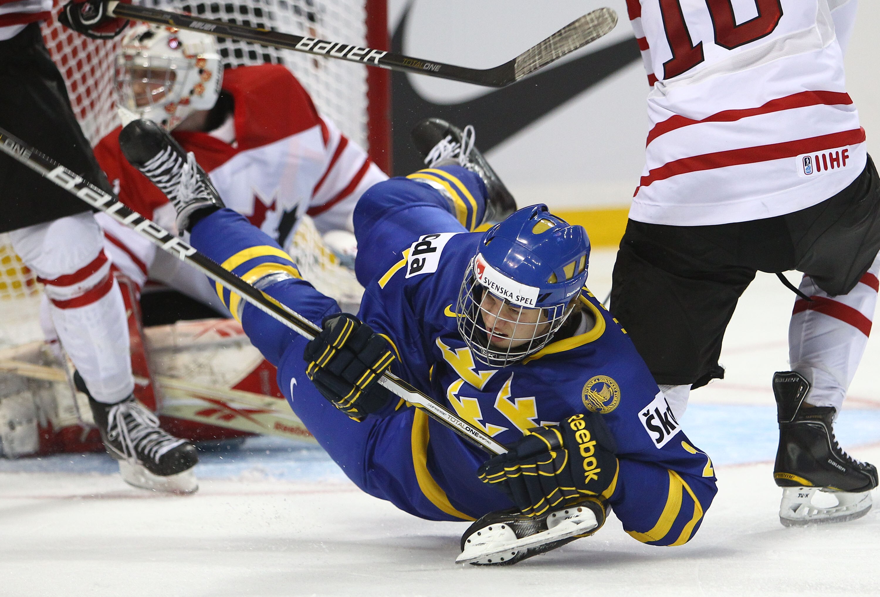 BUFFALO, NY - DECEMBER 31: Forward Rickard Rakell #27 of Sweden is dumped to the ice during the 2011 IIHF World U20 Championship game between Canada and Sweden on December 31, 2010 at HSBC Arena in Buffalo, New York. (Photo by Tom Szczerbowski/Getty Image