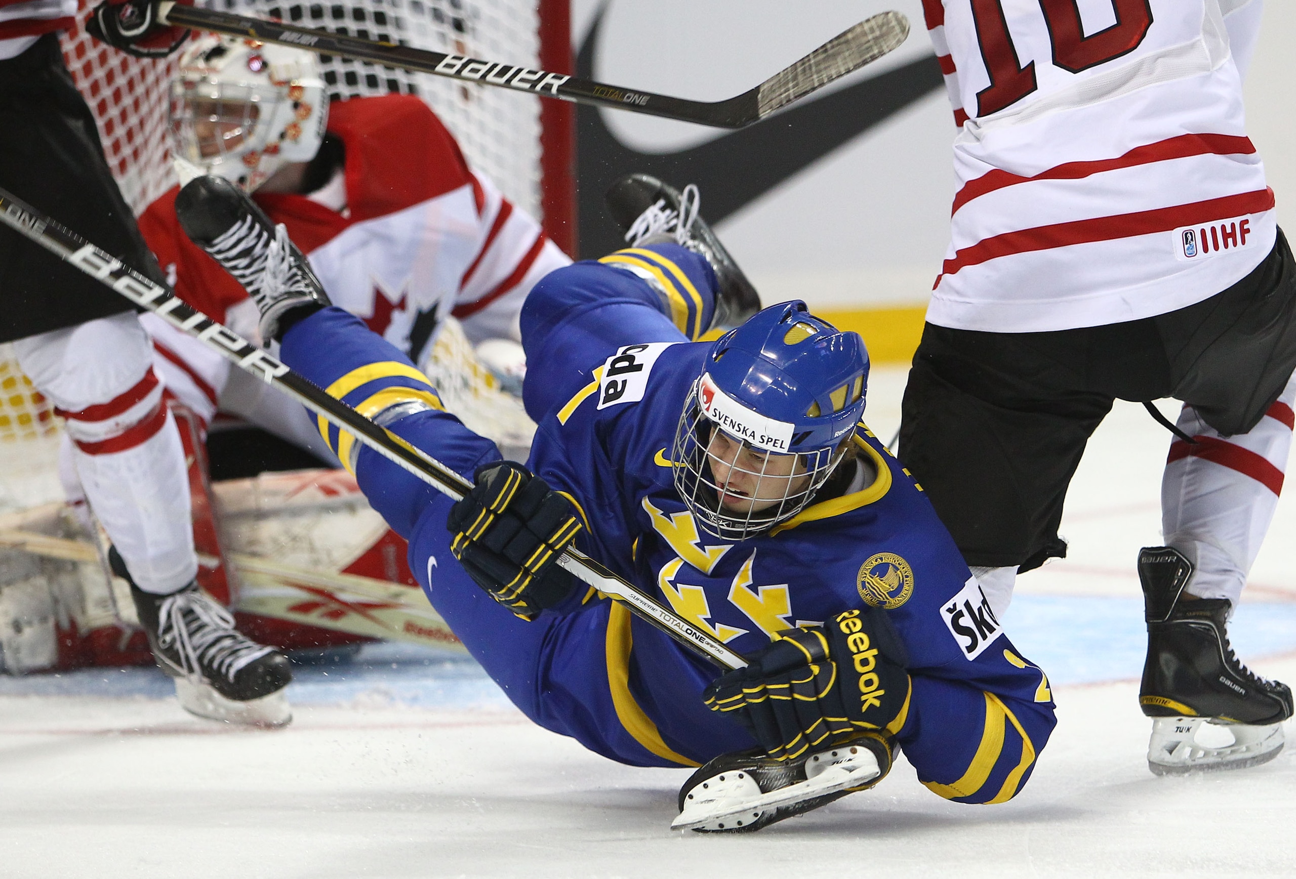 BUFFALO, NY - DECEMBER 31: Forward Rickard Rakell #27 of Sweden is dumped to the ice during the 2011 IIHF World U20 Championship game between Canada and Sweden on December 31, 2010 at HSBC Arena in Buffalo, New York. (Photo by Tom Szczerbowski/Getty Image