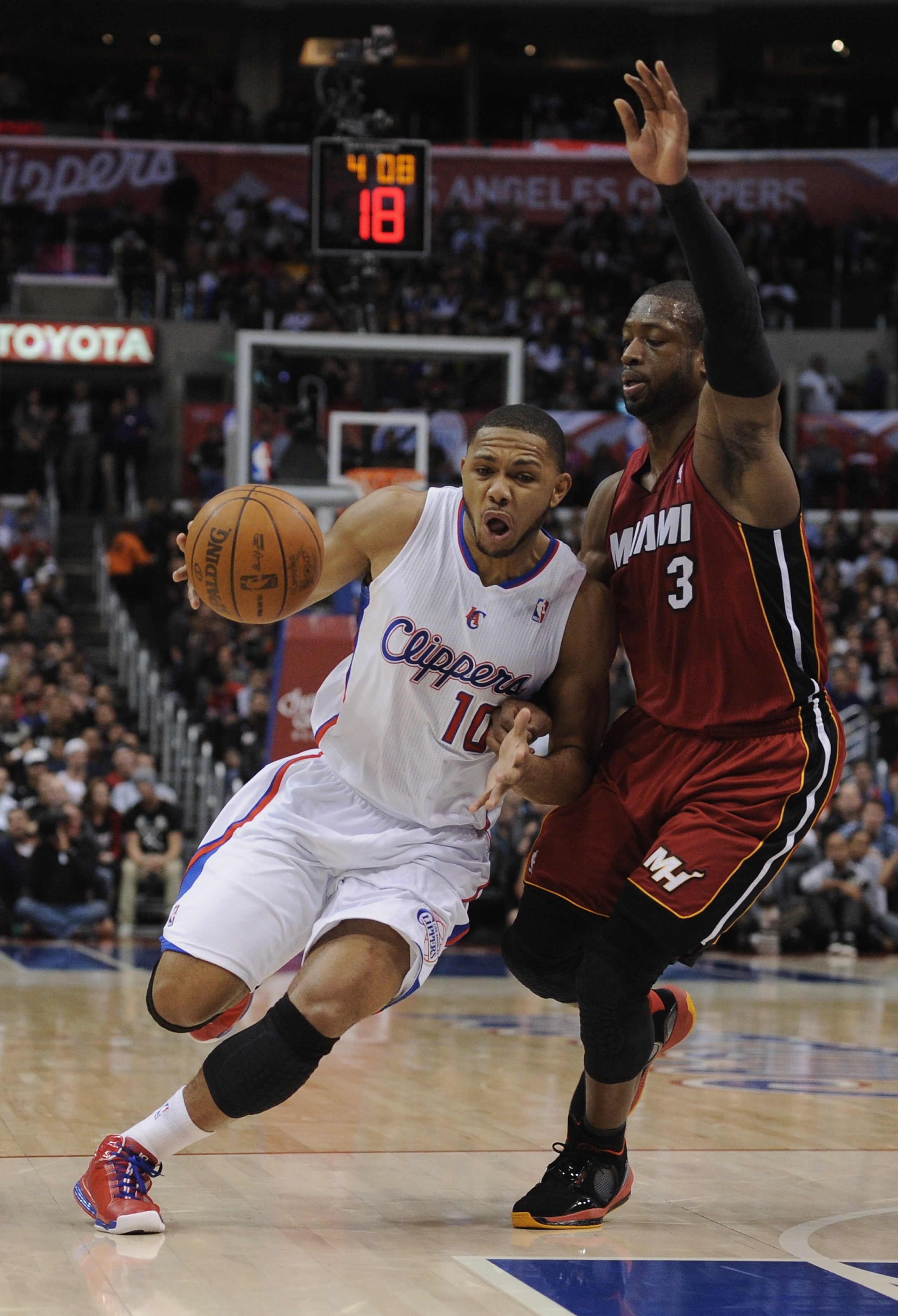 LOS ANGELES, CA - JANUARY 12:  Eric Gordon #10 of the Los Angeles Clippers heads to the basket as he is guarded by Dwyane Wade #3 of the Miami Heat at Staples Center on January 12, 2011 in Los Angeles, California.  NOTE TO USER: User expressly acknowledge