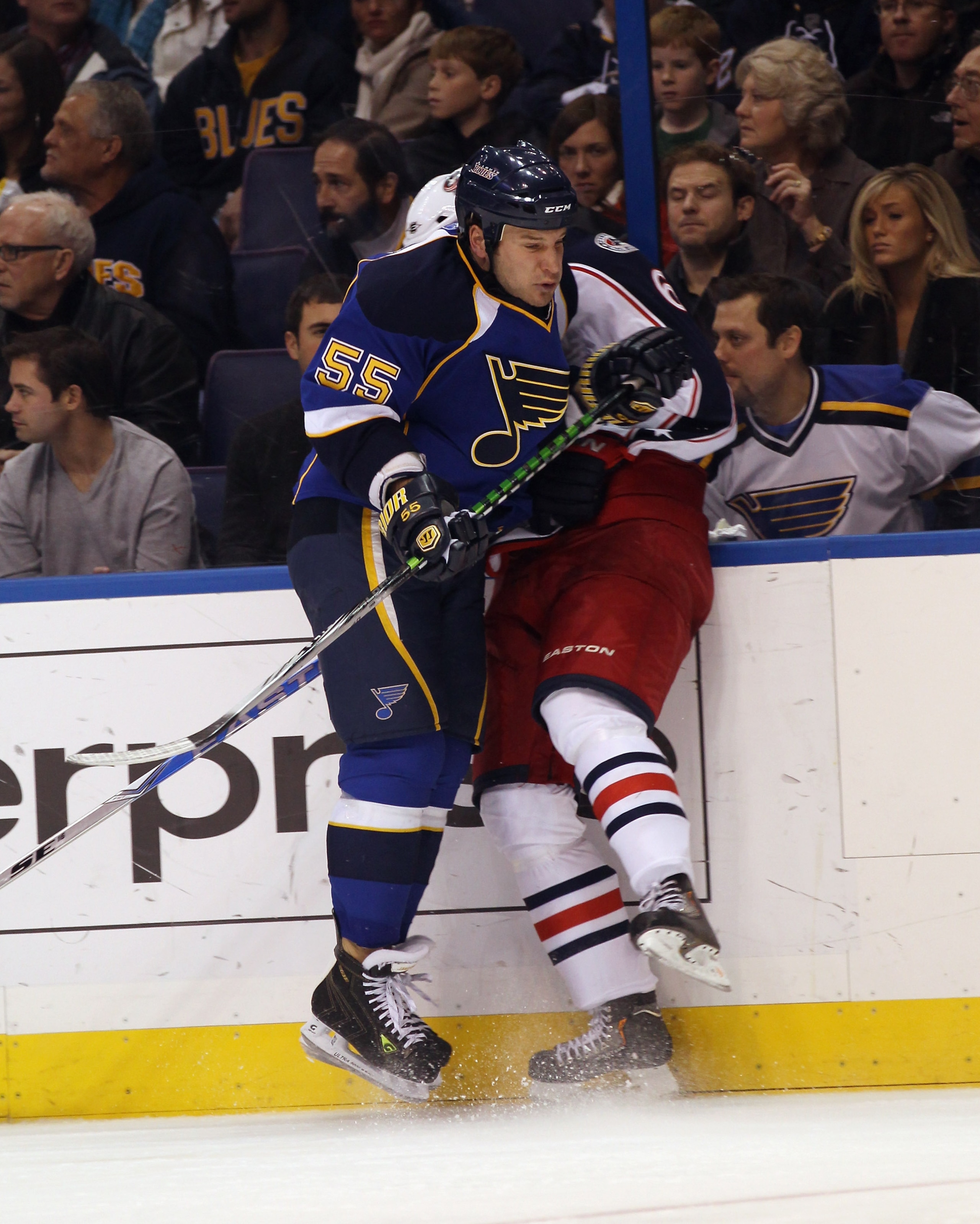 ST LOUIS, MO - DECEMBER 09:  Cam Janssen #55 of the St. Louis Blues hits Anton Stralman #6 of the Columbus Blue Jackets at the Scottrade Center on December 9, 2010 in St Louis, Missouri.  (Photo by Bruce Bennett/Getty Images)