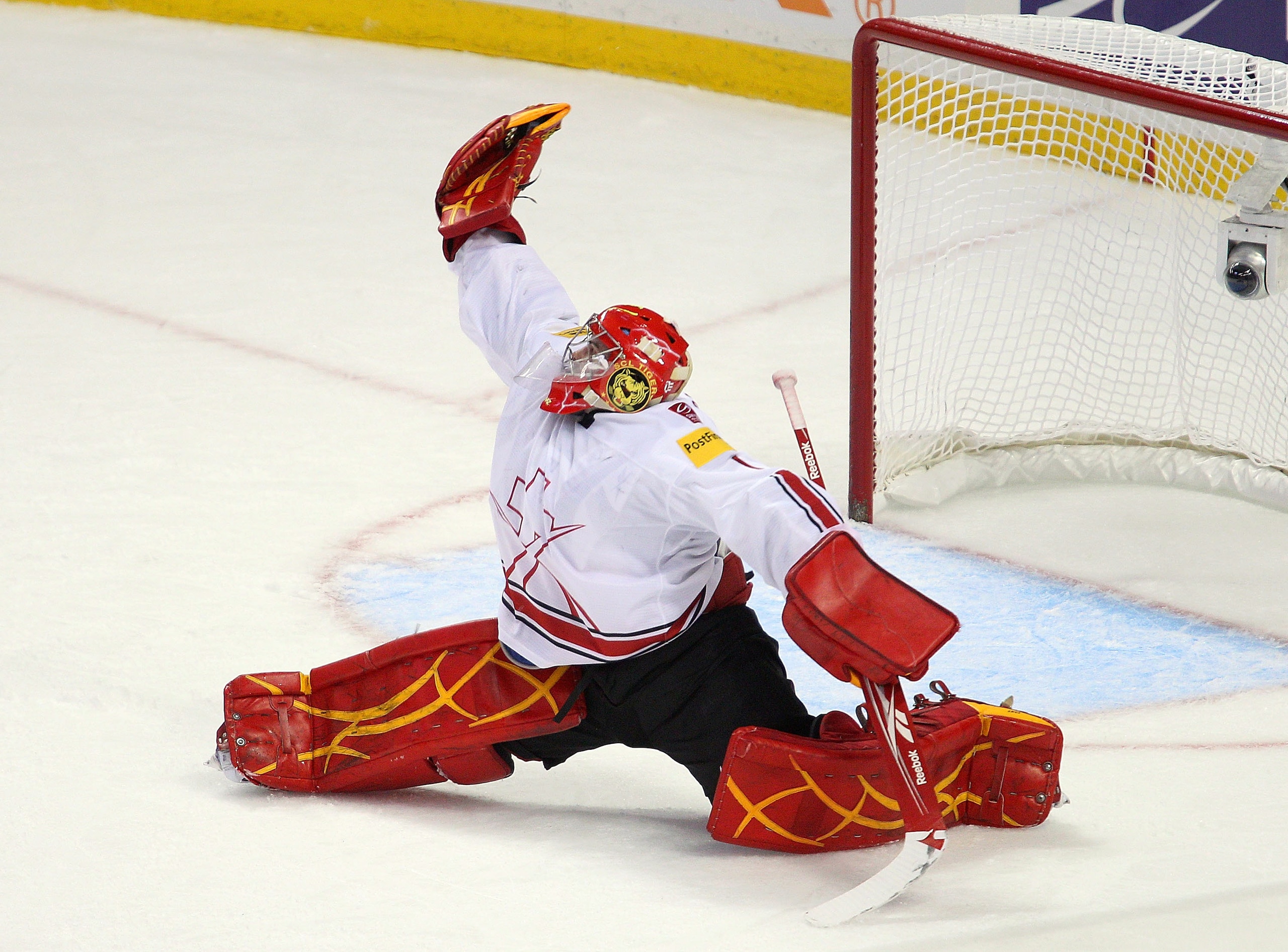 BUFFALO, NY - JANUARY 02: Benjamin Conz #1 of Switzerland makes a glove save against Canada  during the 2011 IIHF World U20 Championship game between Canada and Switzerland on January 2, 2011 in Buffalo, New York.  (Photo by Rick Stewart/Getty Images)