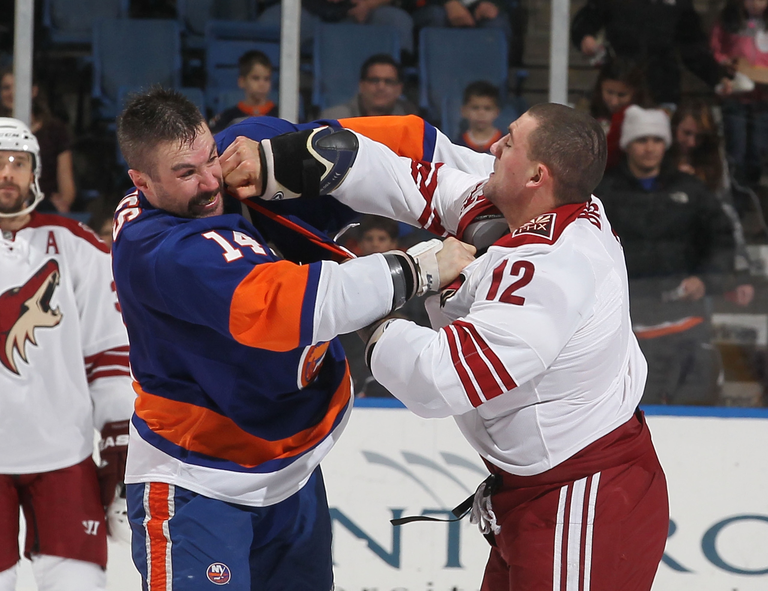UNIONDALE, NY - DECEMBER 18:  Trevor Gillies #14 of the New York Islanders fights Paul Bissonnette #12 of the Phoenix Coyotes during their game on December 18, 2010 at the Nassau Coliseum in Uniondale, New York.  (Photo by Al Bello/Getty Images)