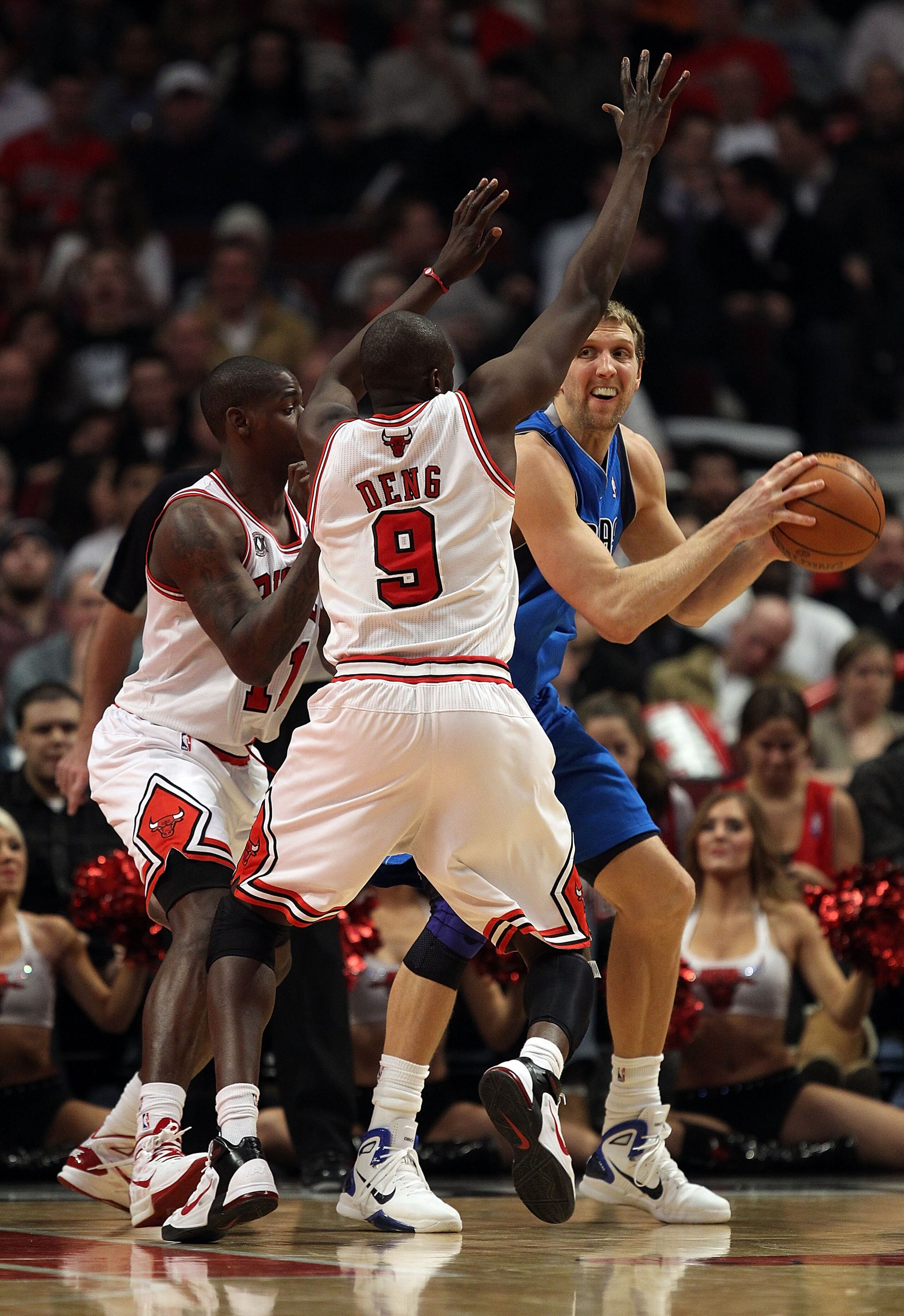 CHICAGO, IL - JANUARY 20: Dirk Nowitzki #41 of the Dallas Mavericks looks to pass under pressure from Ronnie Brewer #11 and Loul Deng #9 of the Chicago Bulls at the United Center on January 20, 2011 in Chicago, Illinois. The Bulls defeated the Mavericks 8